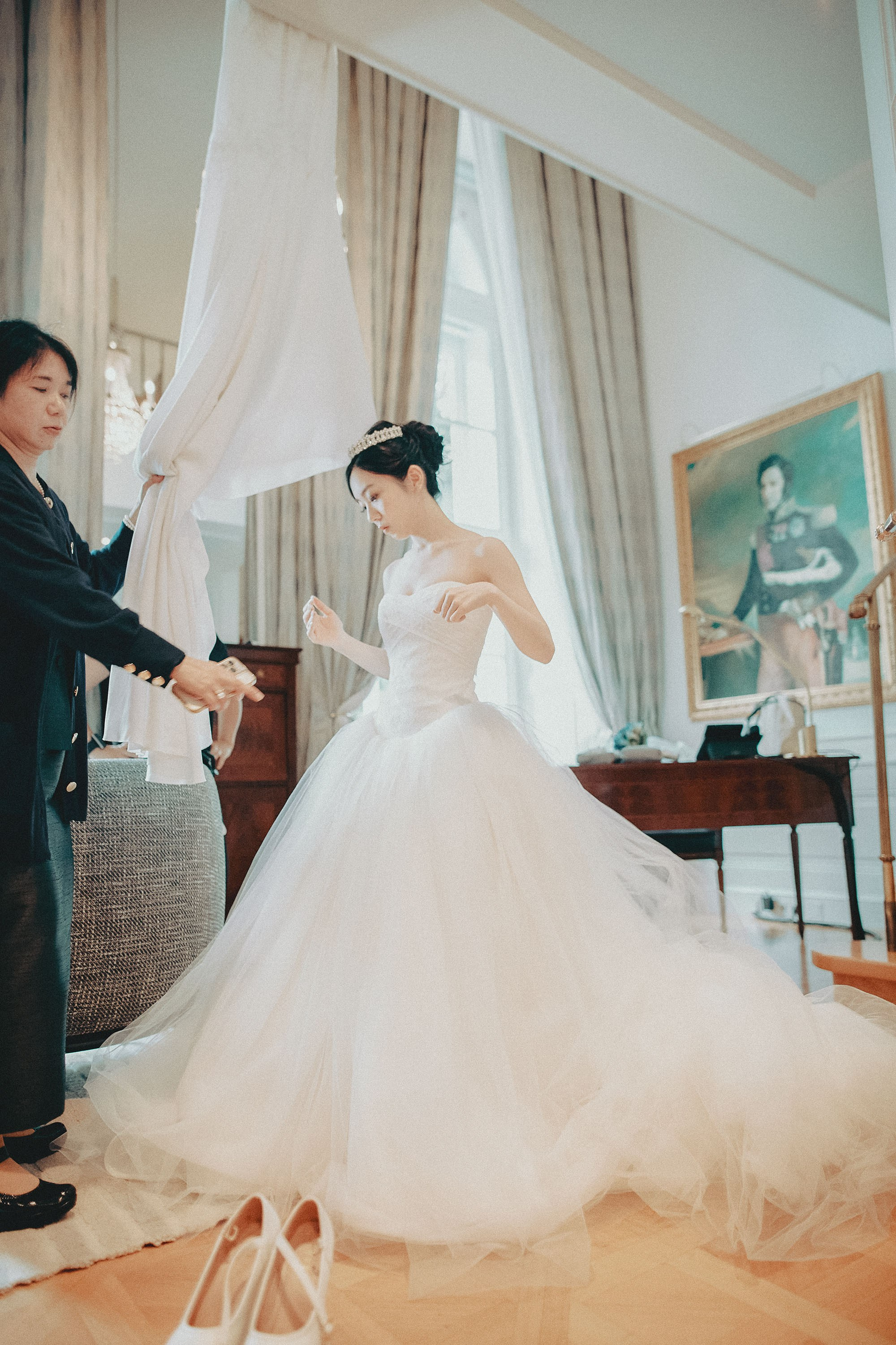 Final adjustments of the brides dress in her suite at the Palais Coburg.