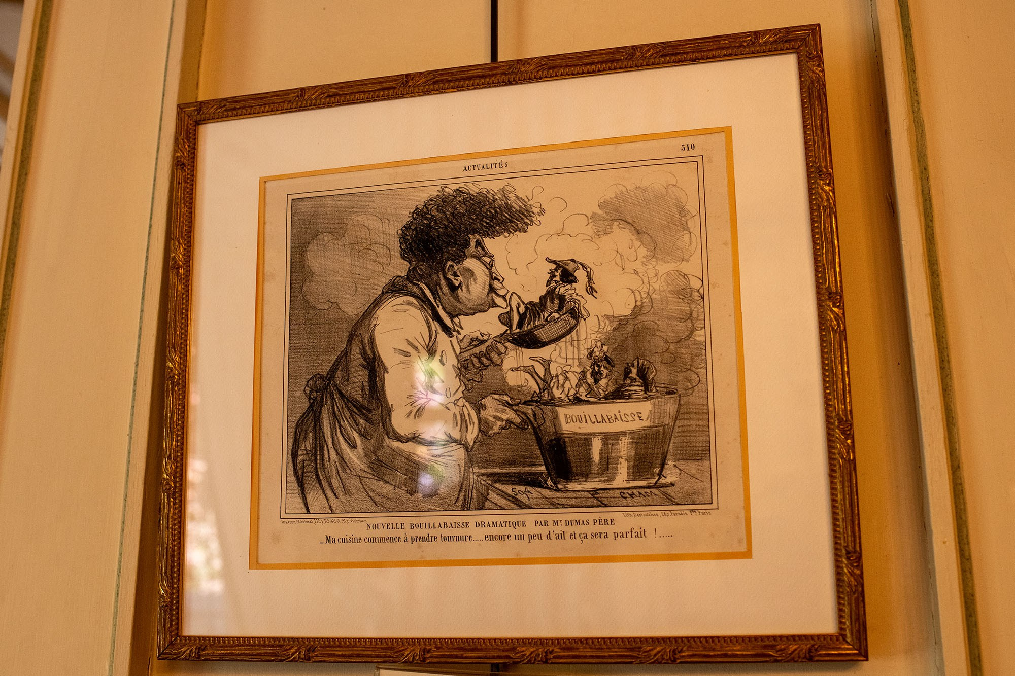 Historic caricature of Alexandre Dumas displayed inside Château de Monte-Cristo museum near Paris