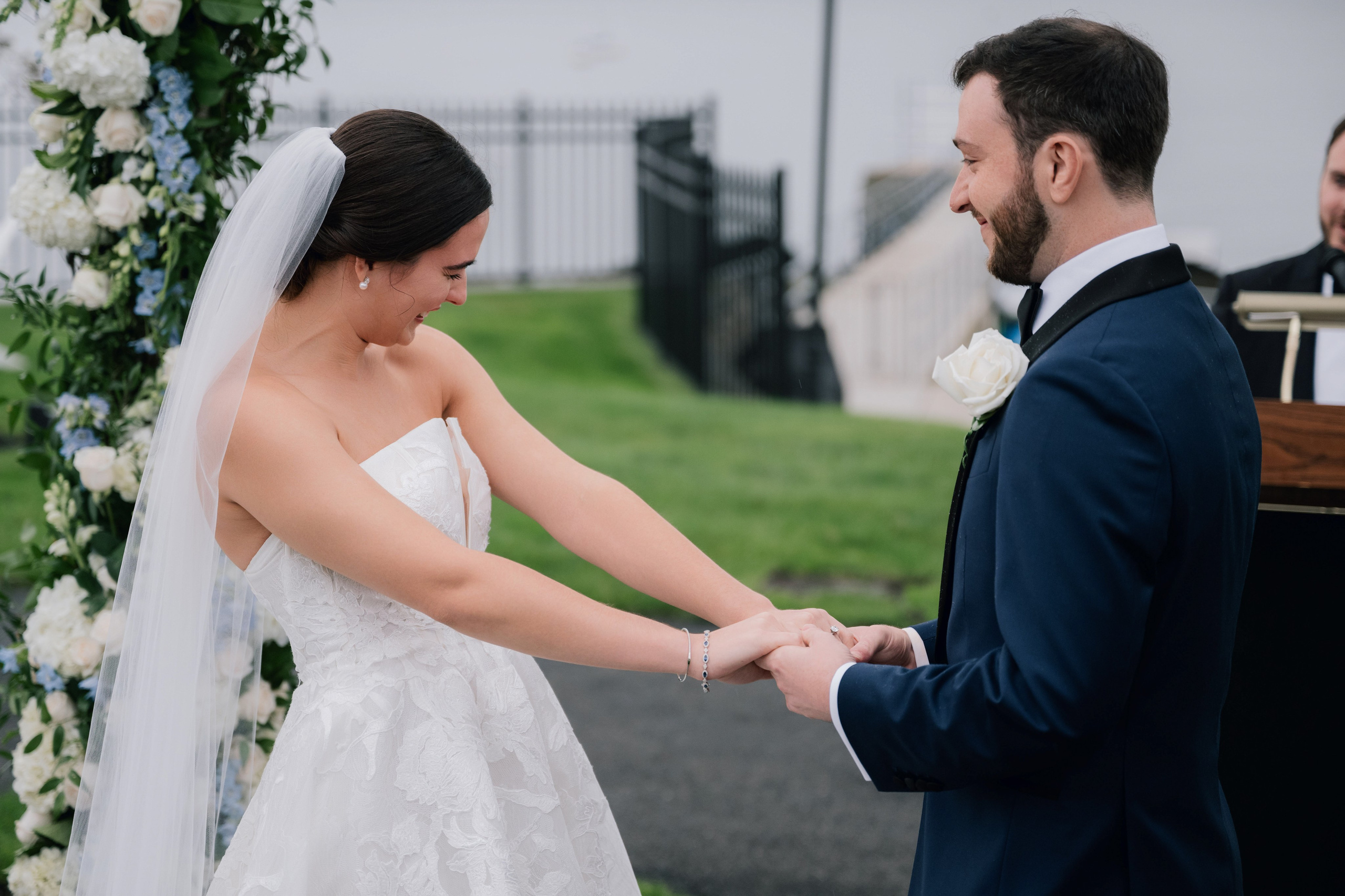 a bride and groom exchanging their hands at their wedding ceremony