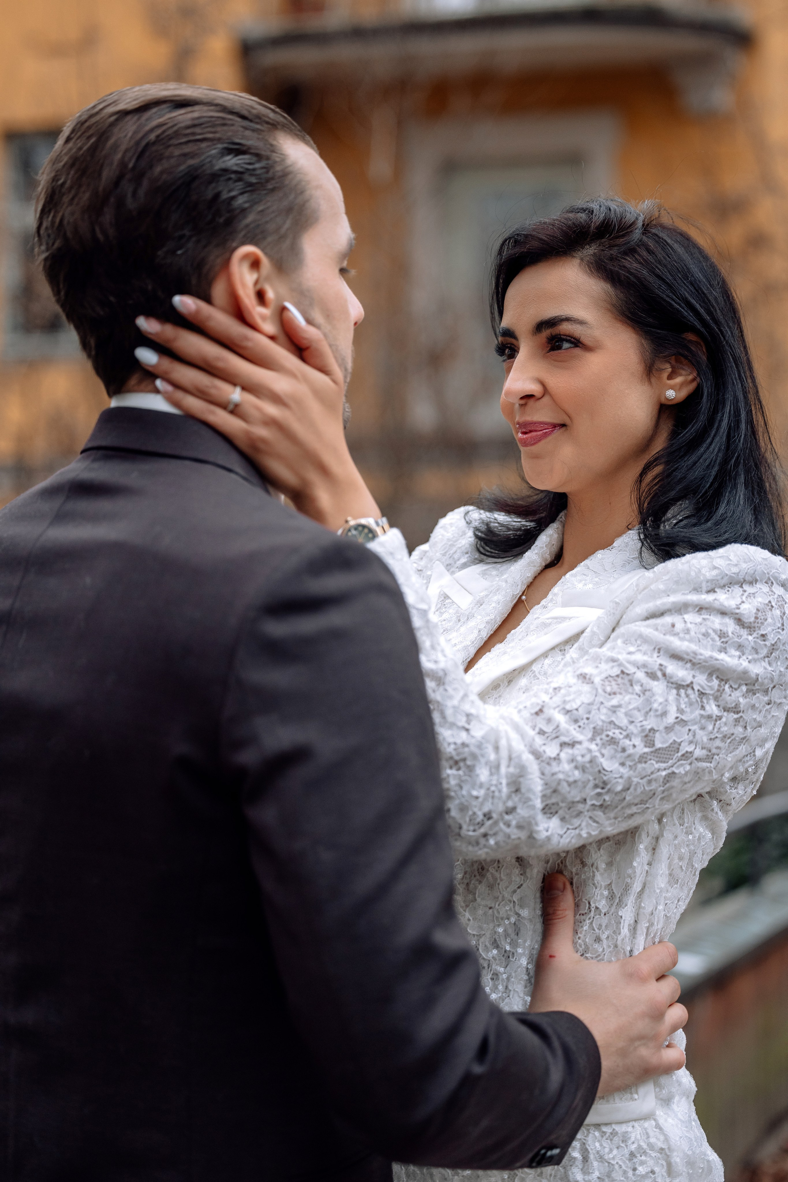 Braut umarmt Bräutigam am Hals – liebevolle Geste Mandlstraße 14