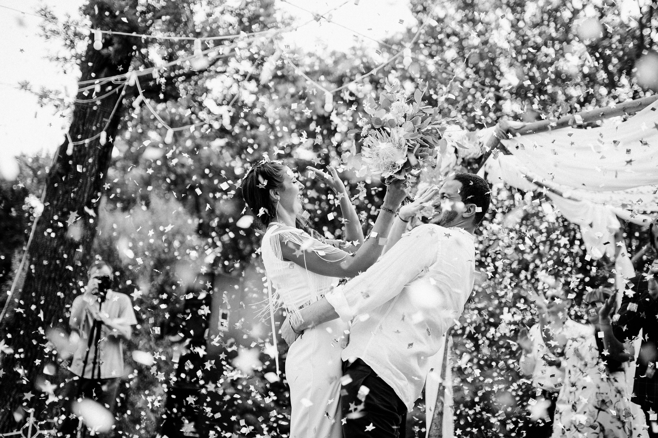 a bride and groom are showered with confe