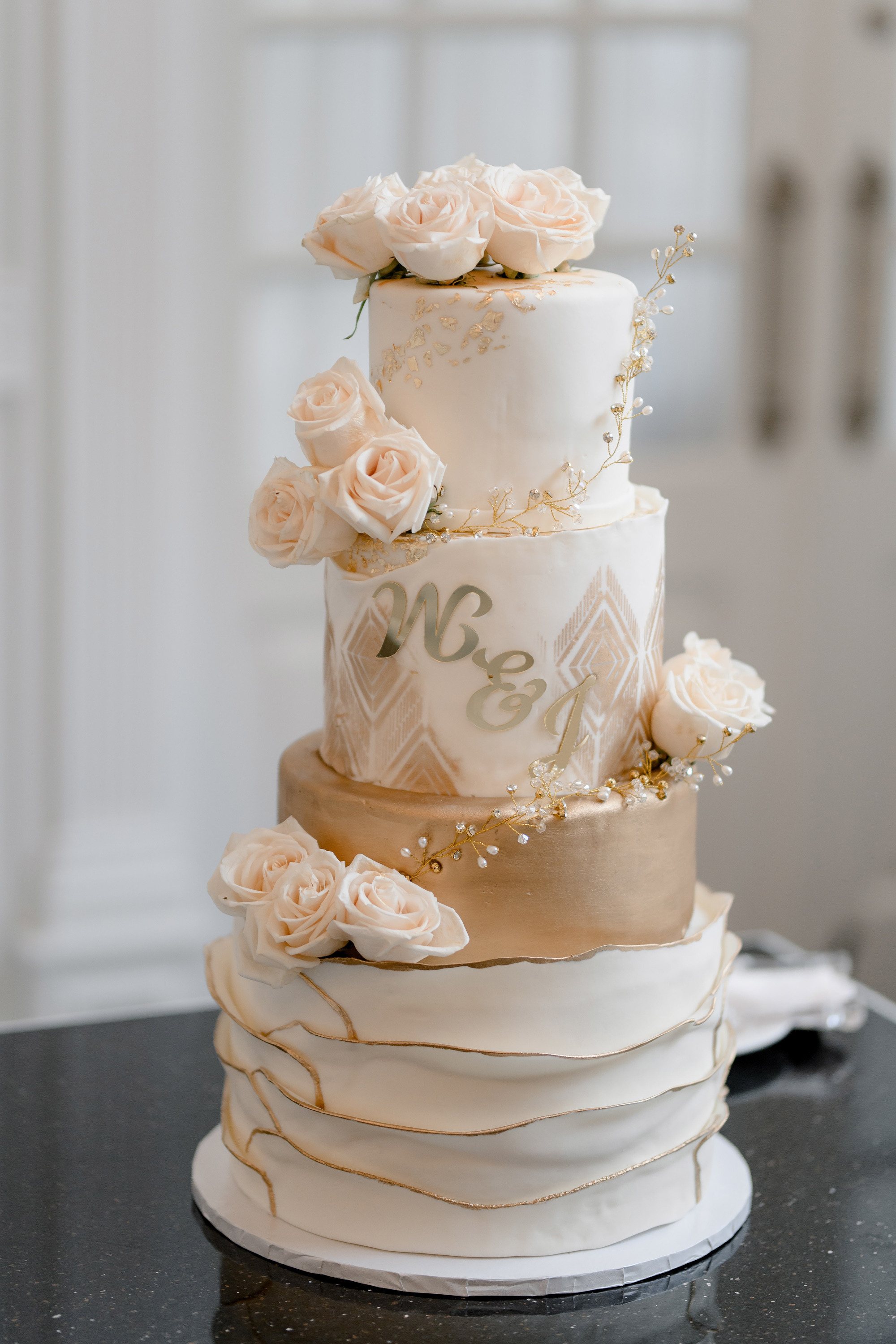 a three tiered cake with white flowers on top