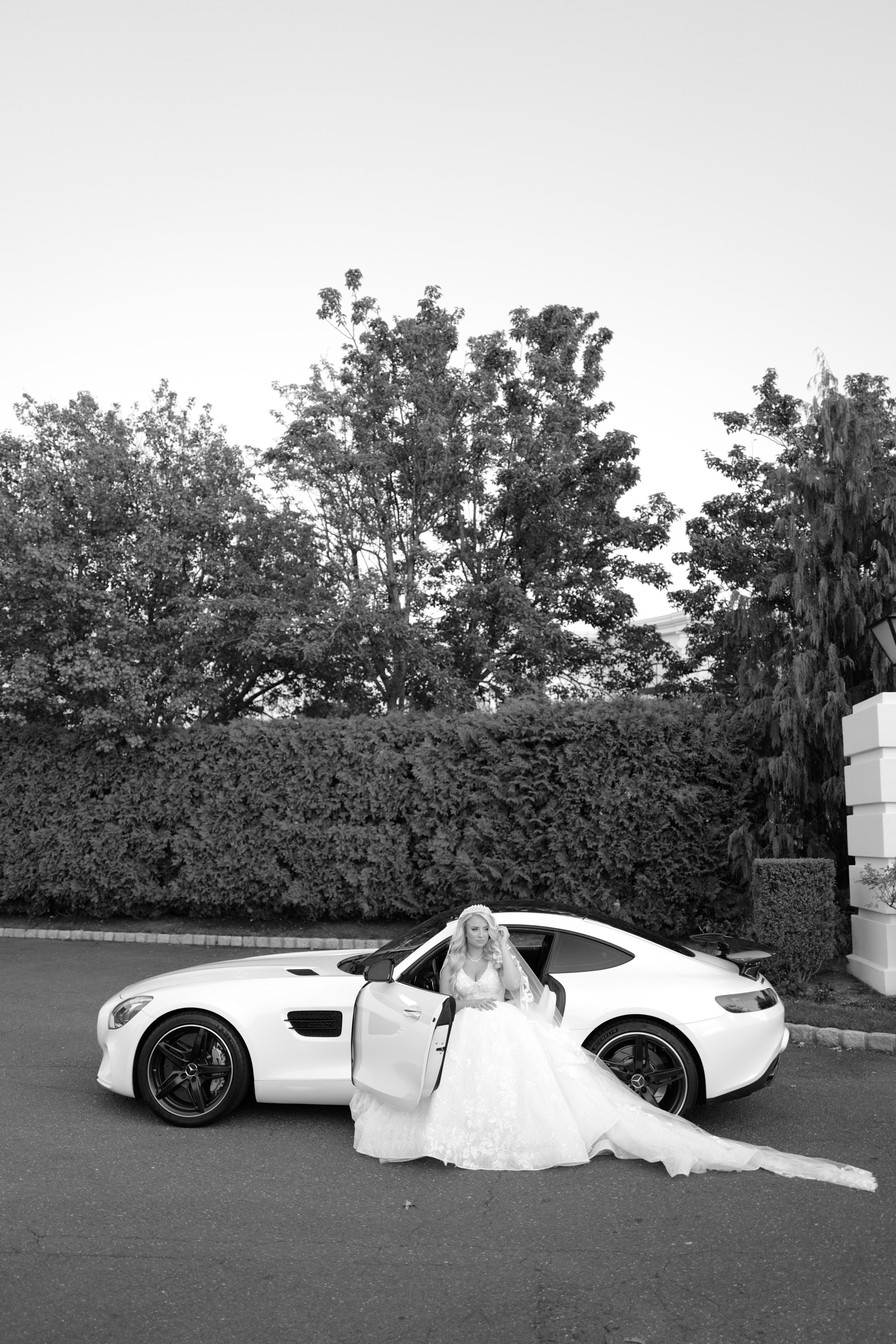 a bride sitting in a white car
