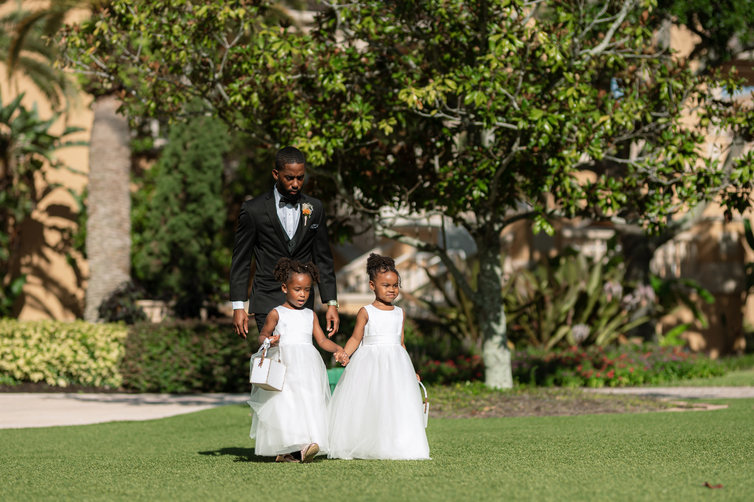 a man and a little girl walking in the grass