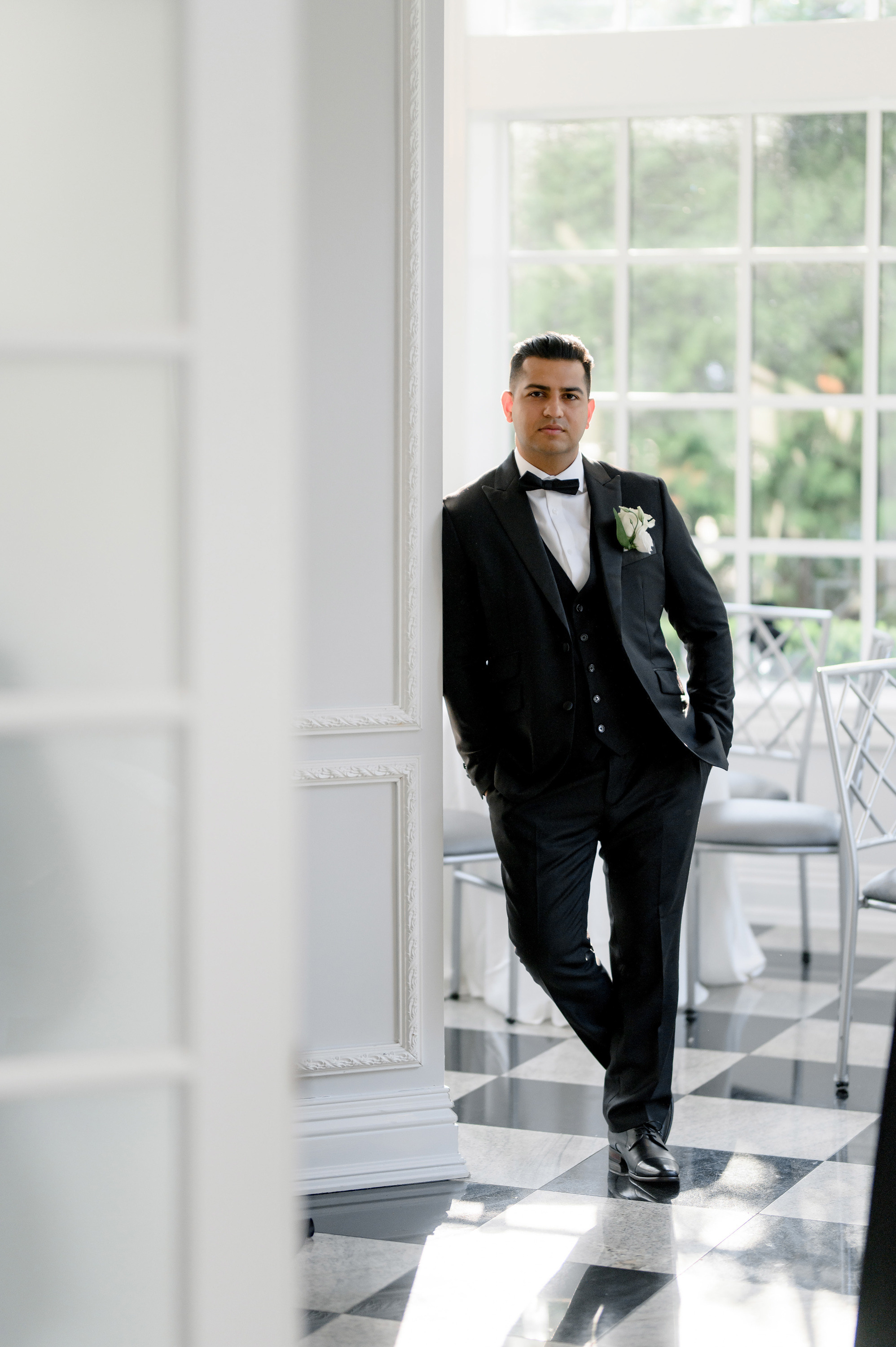 a man in a suit and tie standing in a room