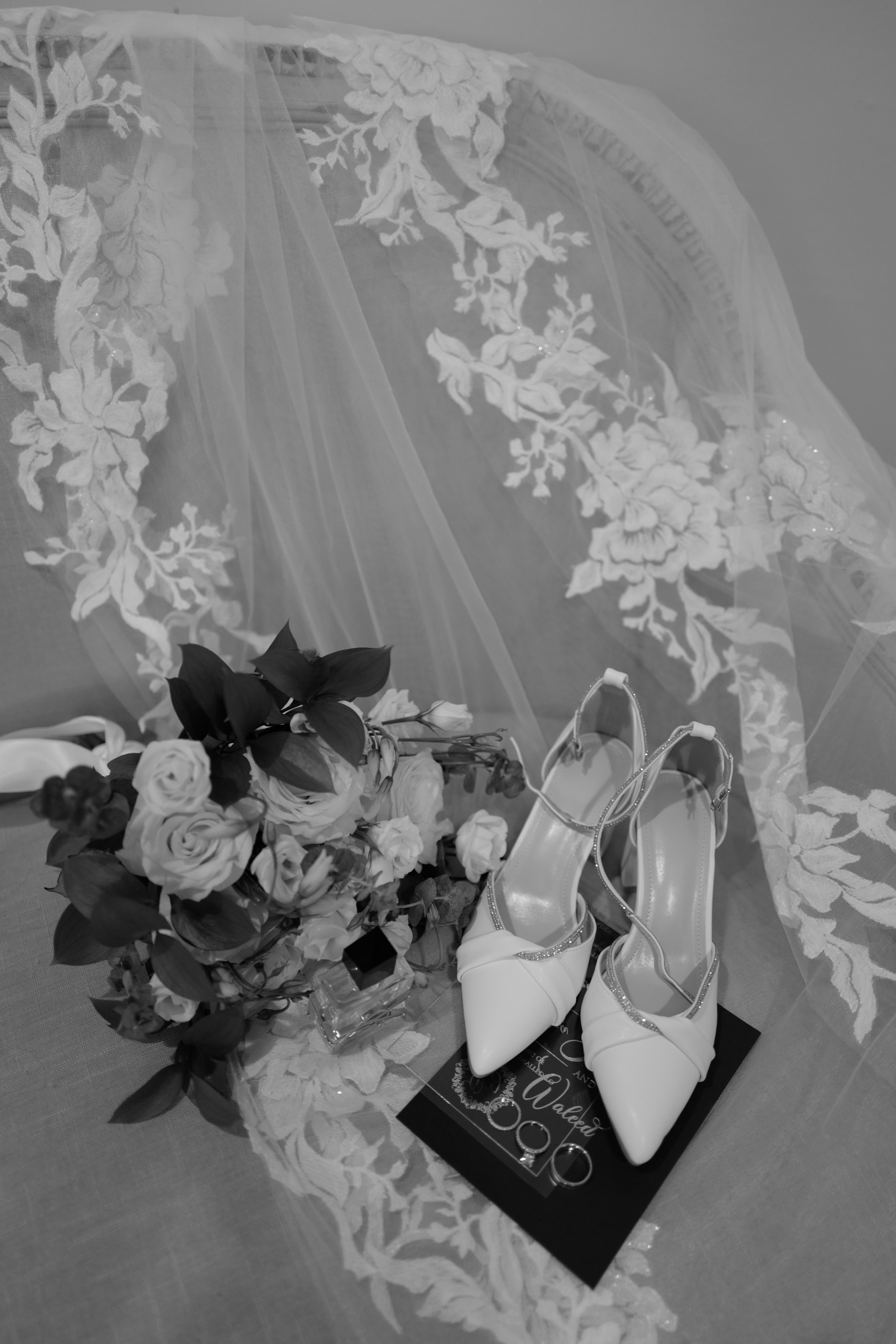 a wedding dress and shoes on a bed