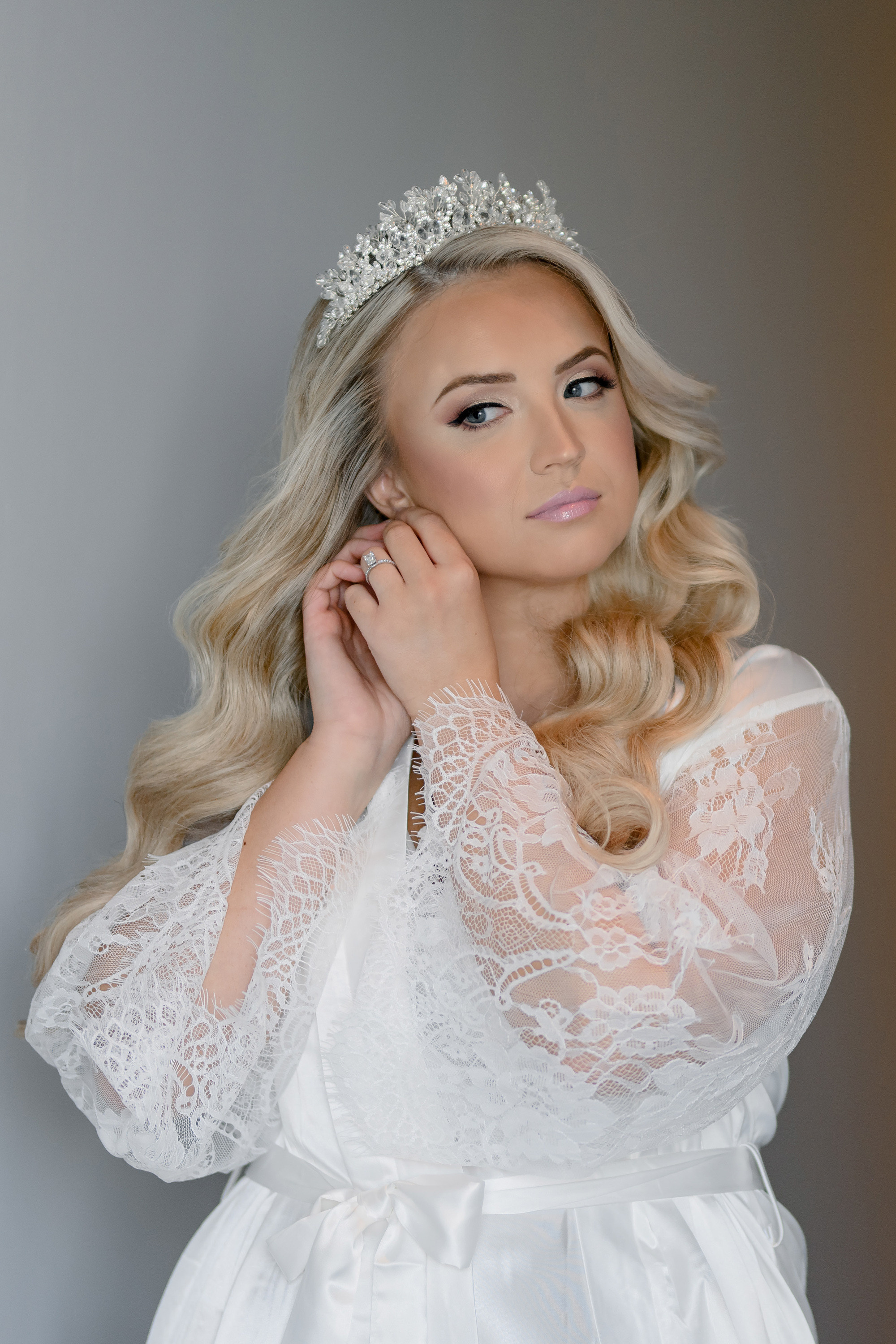 a beautiful blonde bride in a white dress and tia