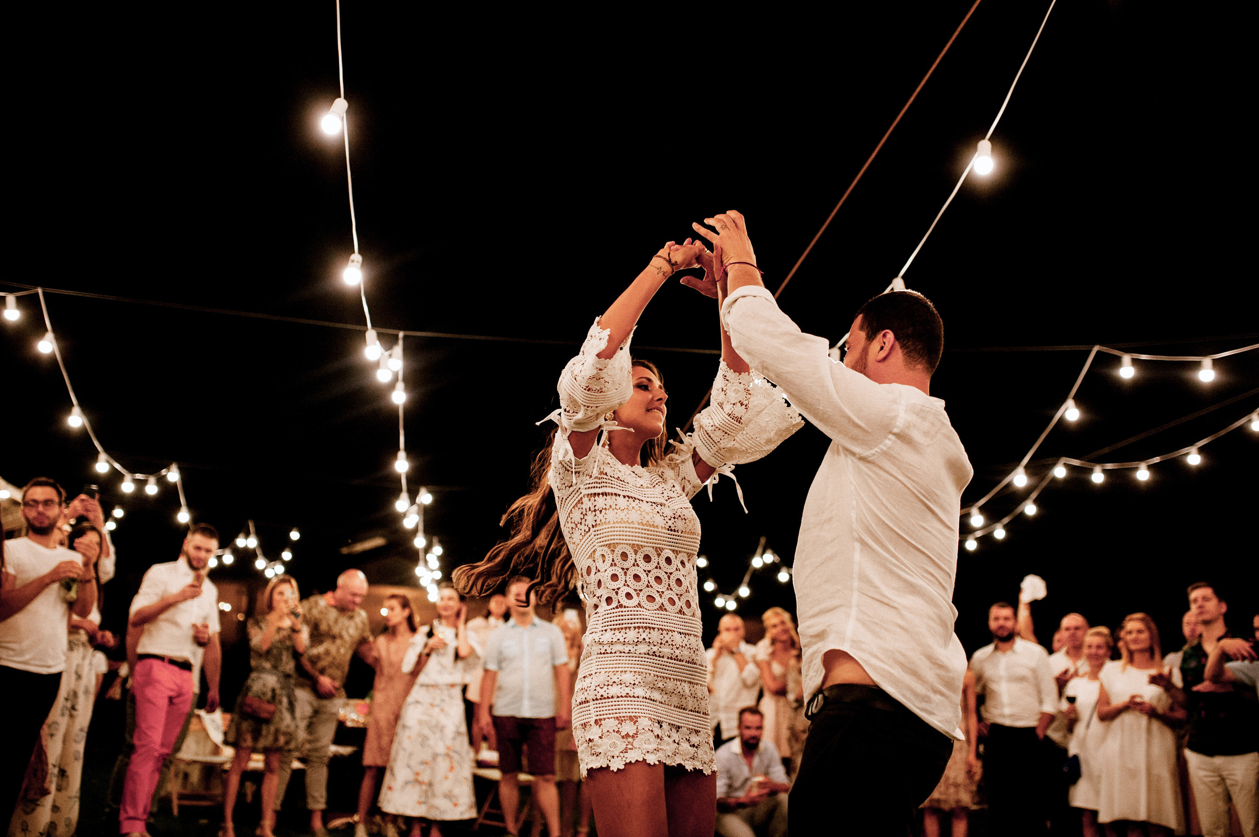 a couple dancing on a dance floor with people watching