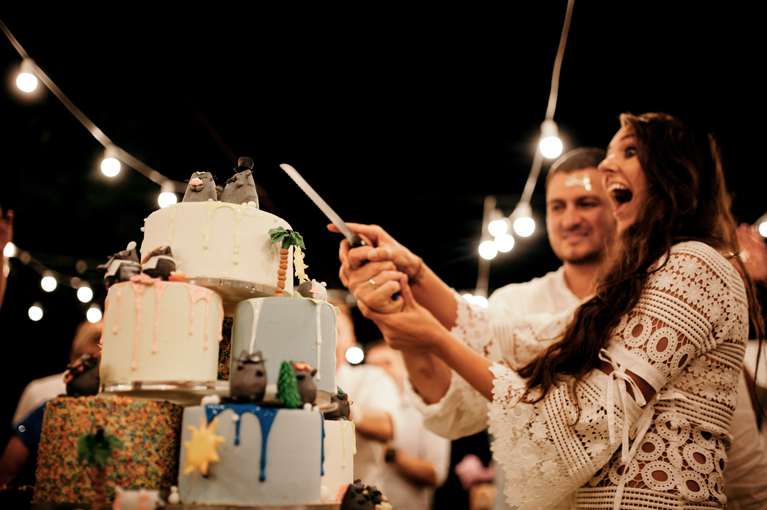a woman is cutting a cake with a knife