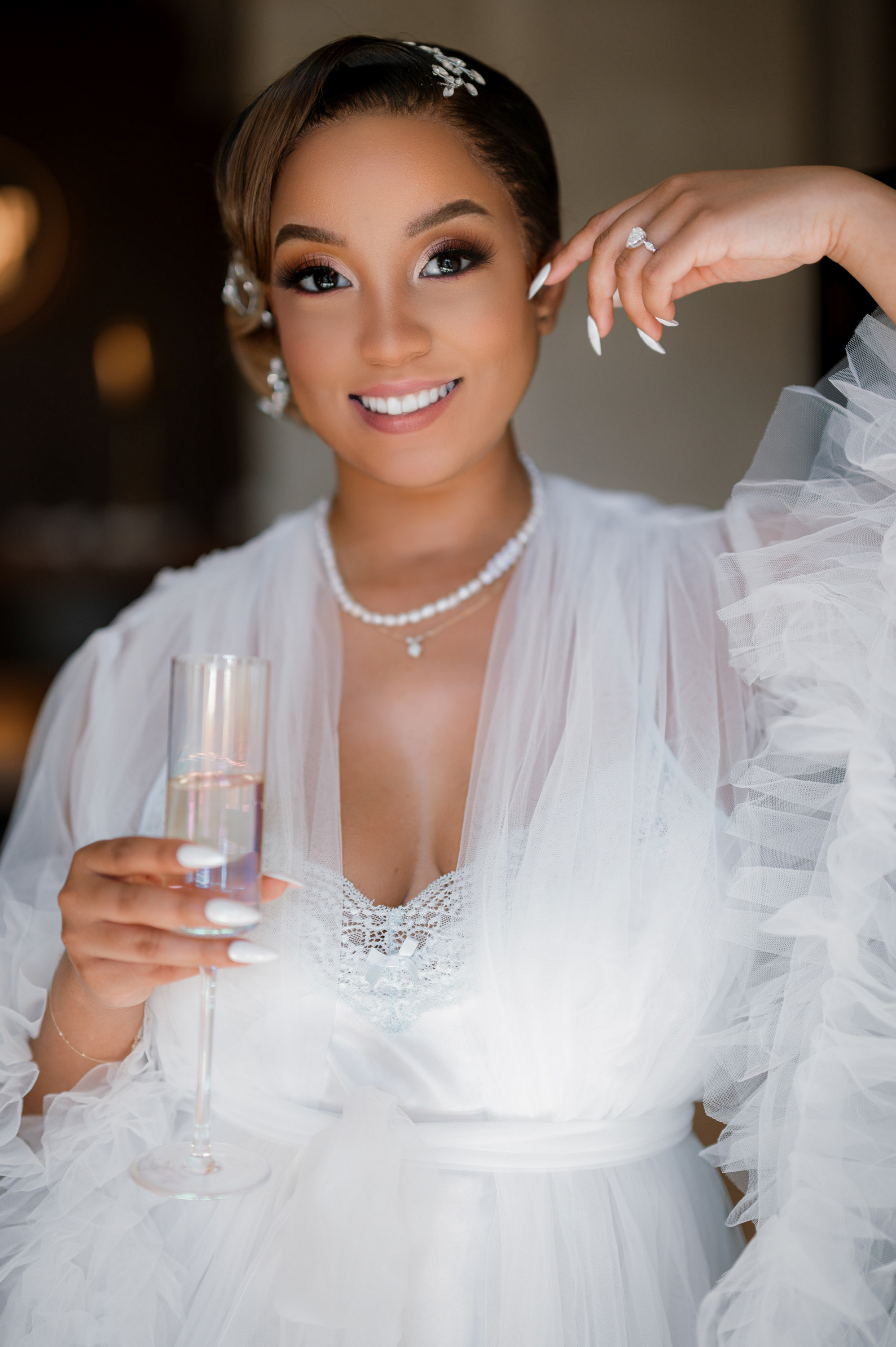 a woman in a white dress holding a glass