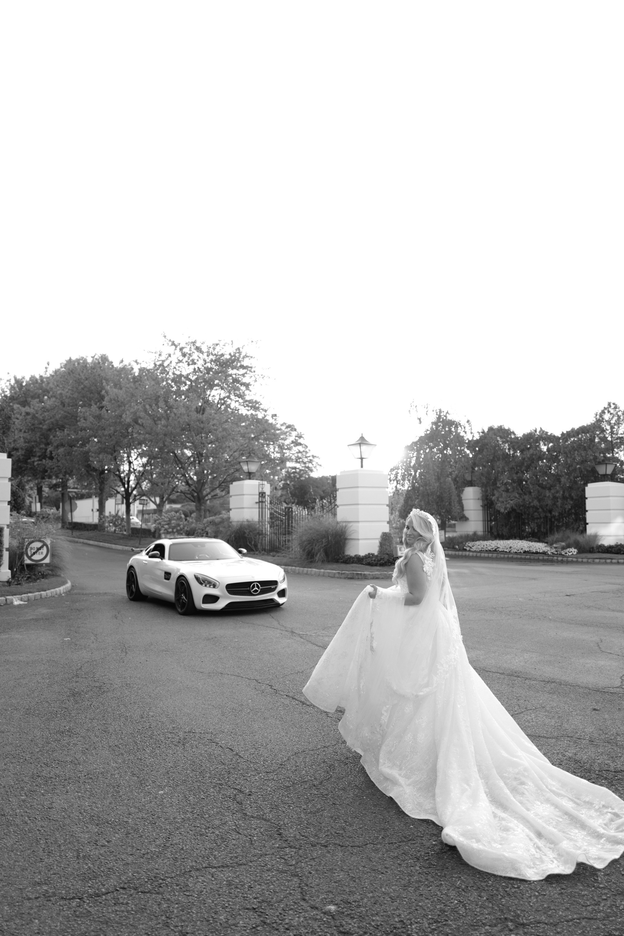 a bride walking down the street with her car