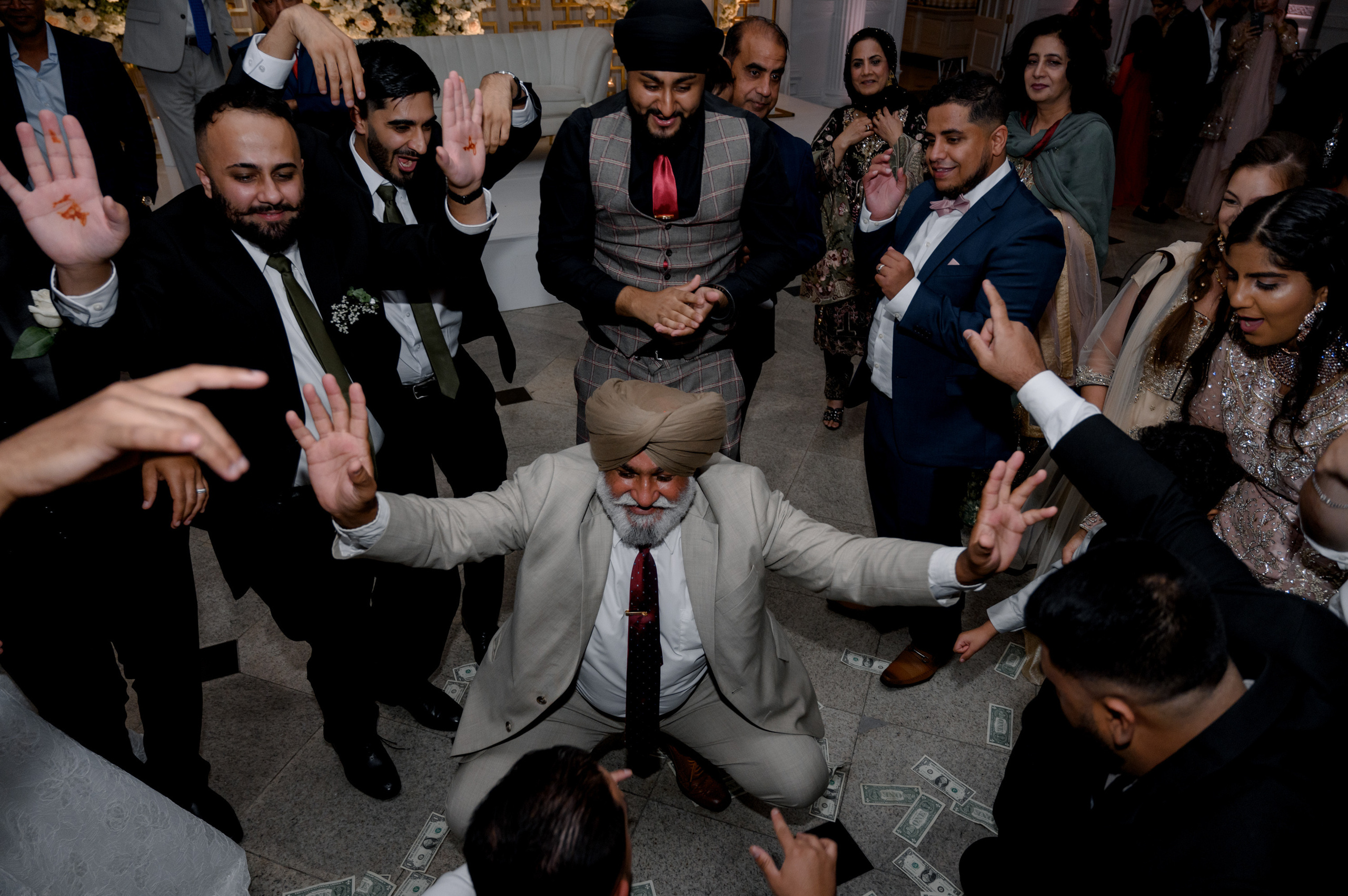 a man in a suit and tie is surrounded by a crowd of people