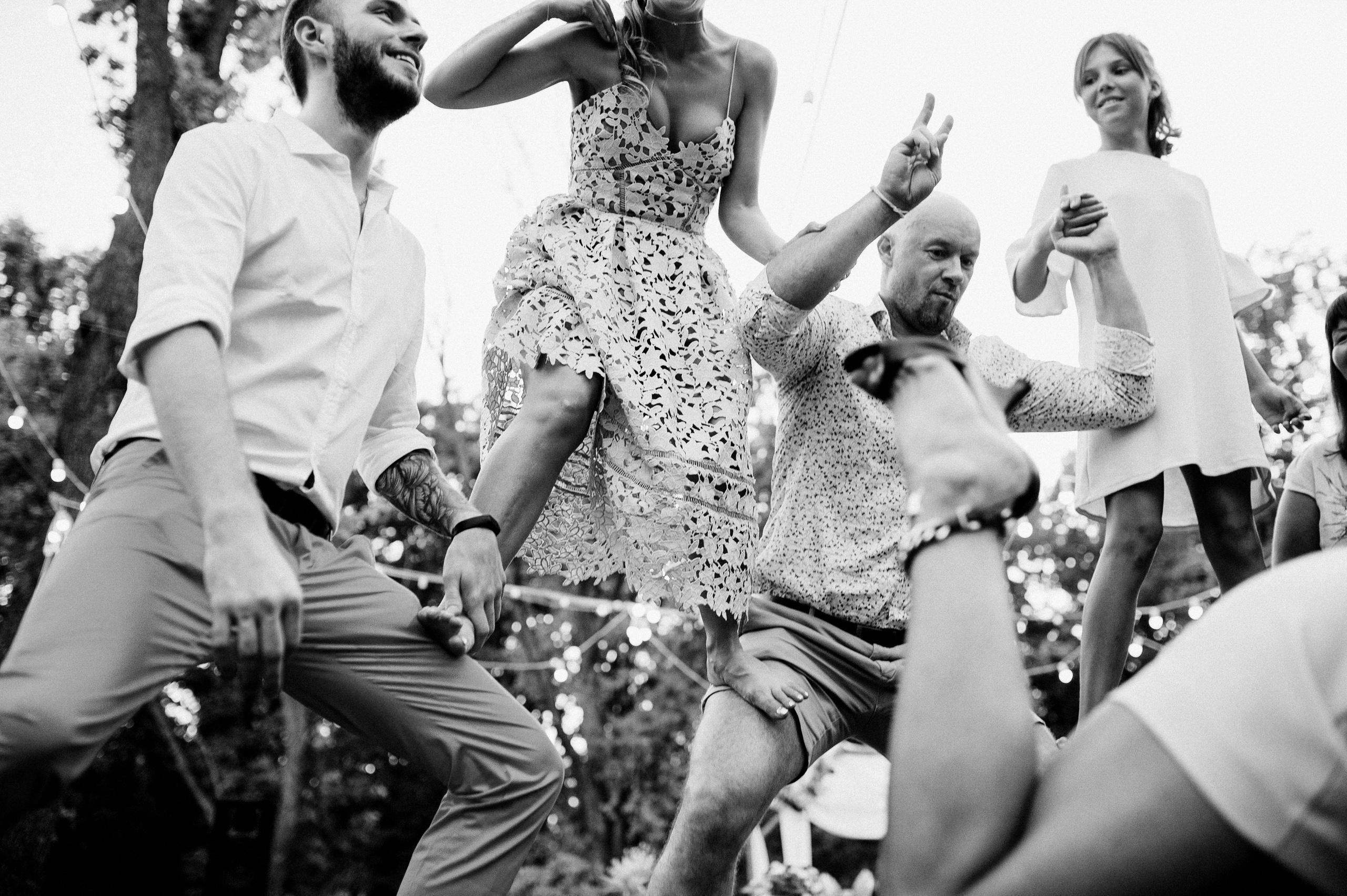a group of people dancing in the middle of a park