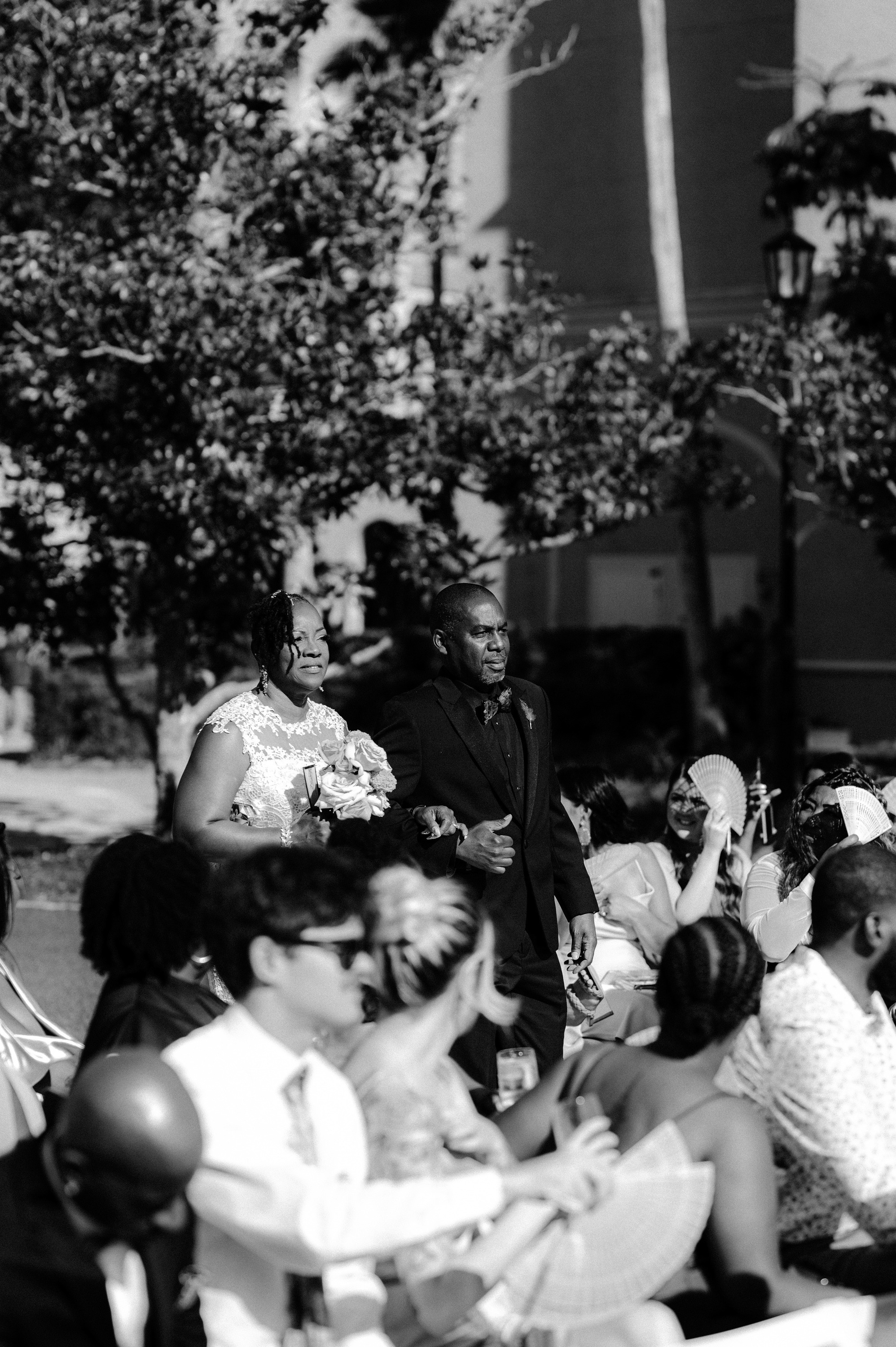 a couple is sitting on a bench in the park