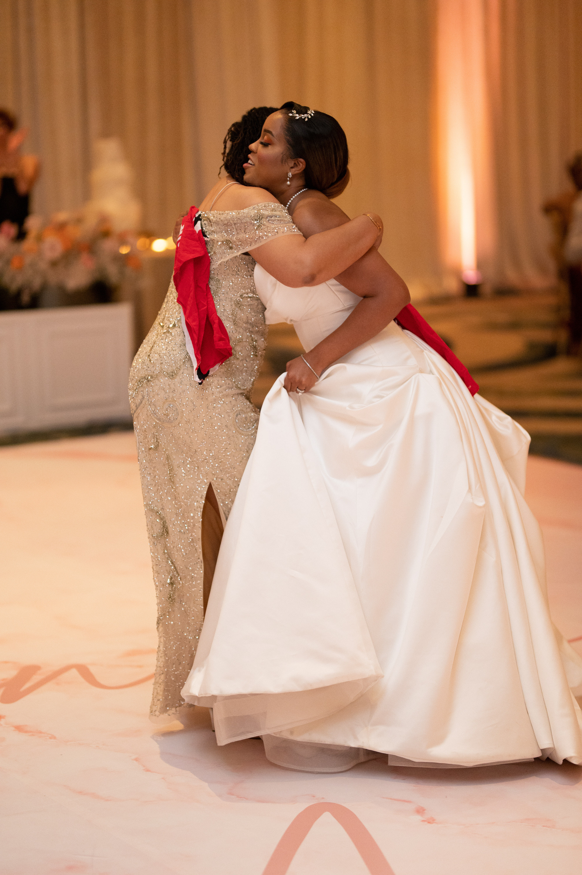 a bride and her mother dance together at a wedding