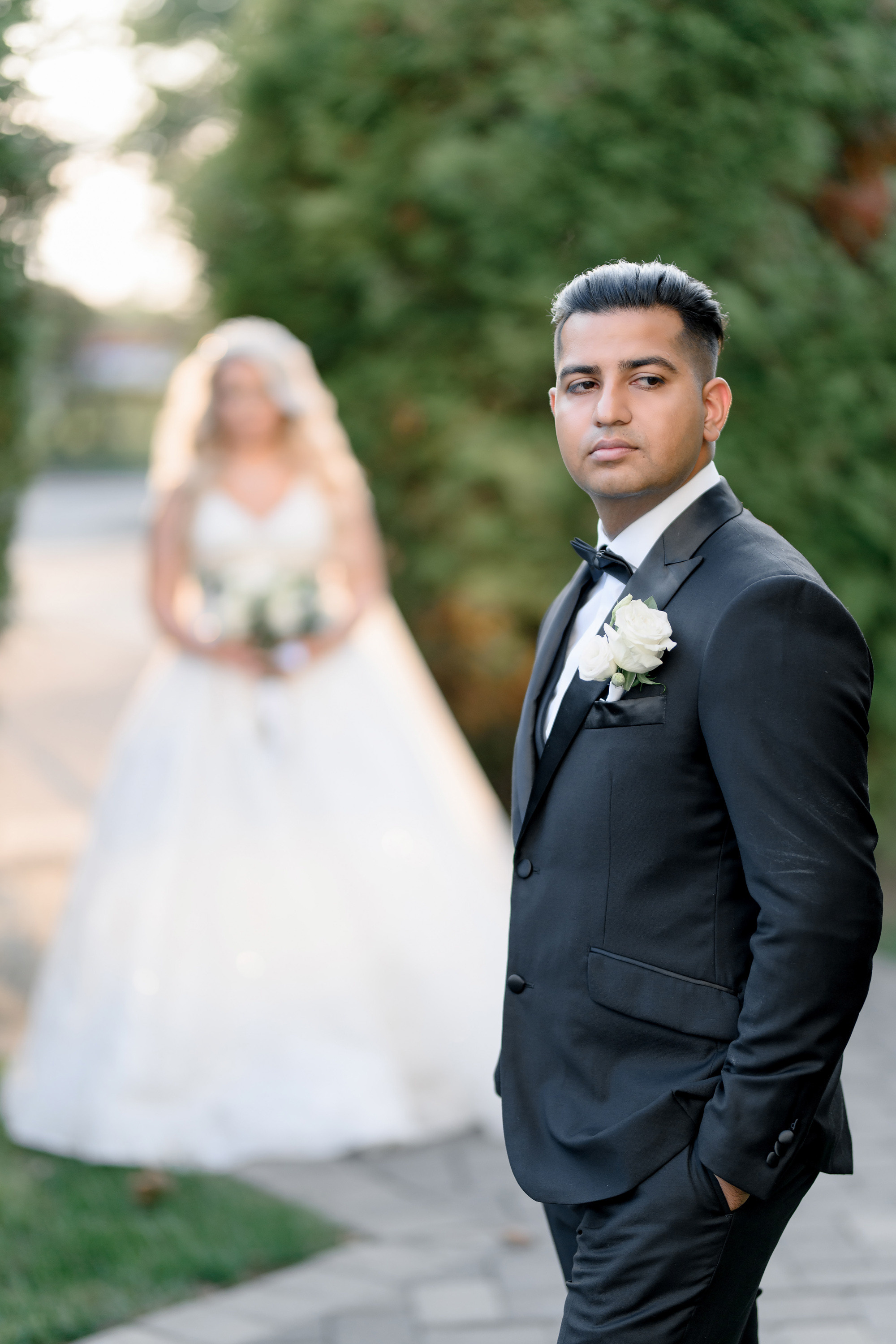 a man in a suit and tie standing next to a woman in a wedding dress