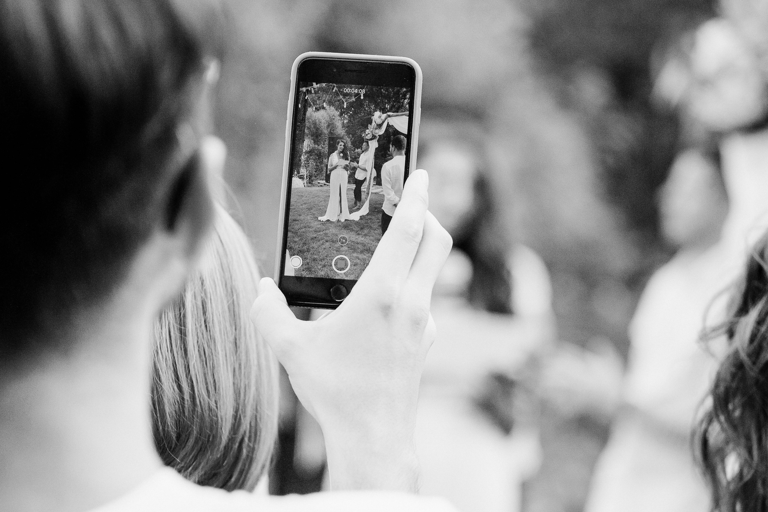 a woman taking a picture of a man