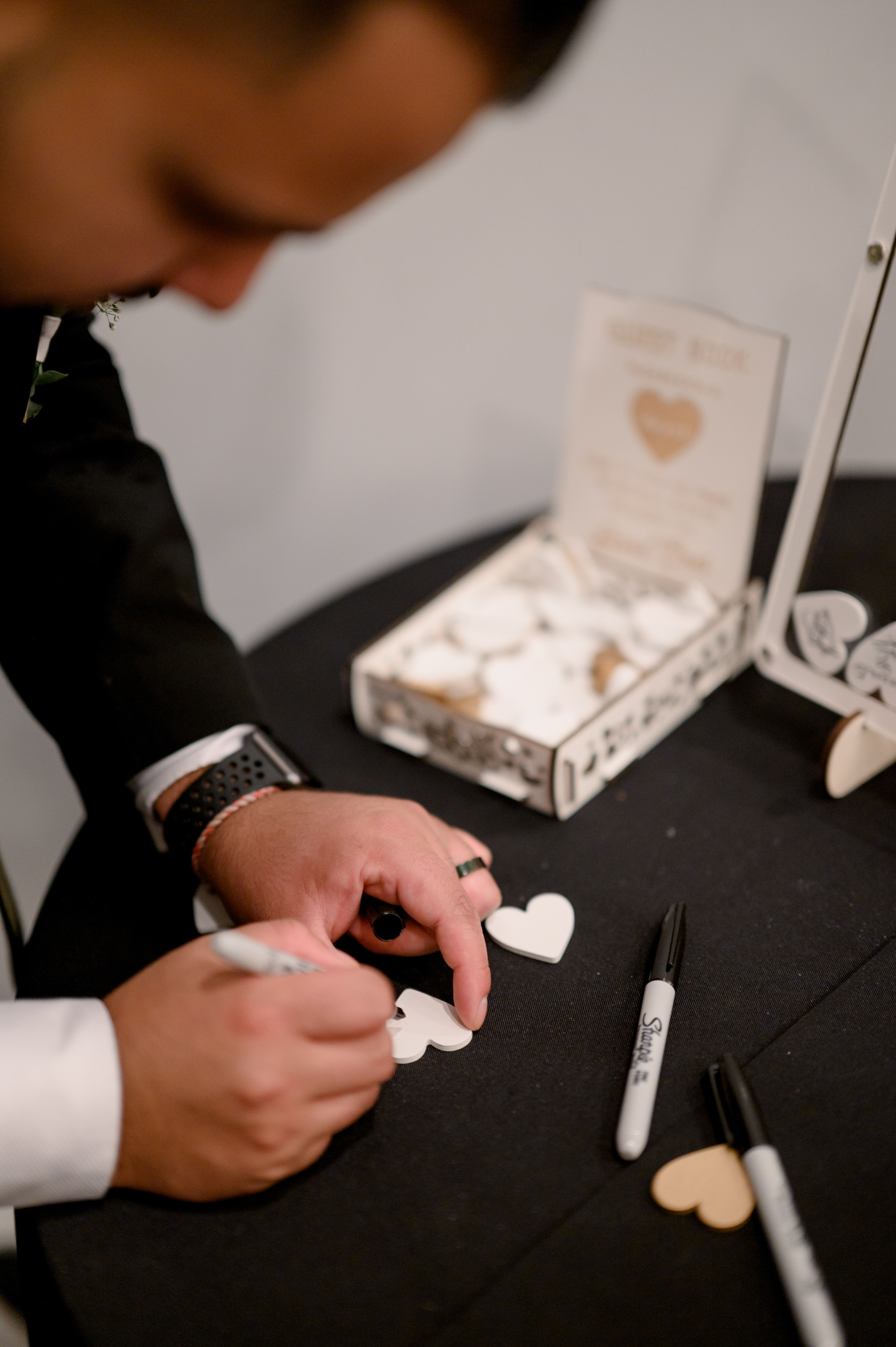 a man in a suit is writing on a piece of paper