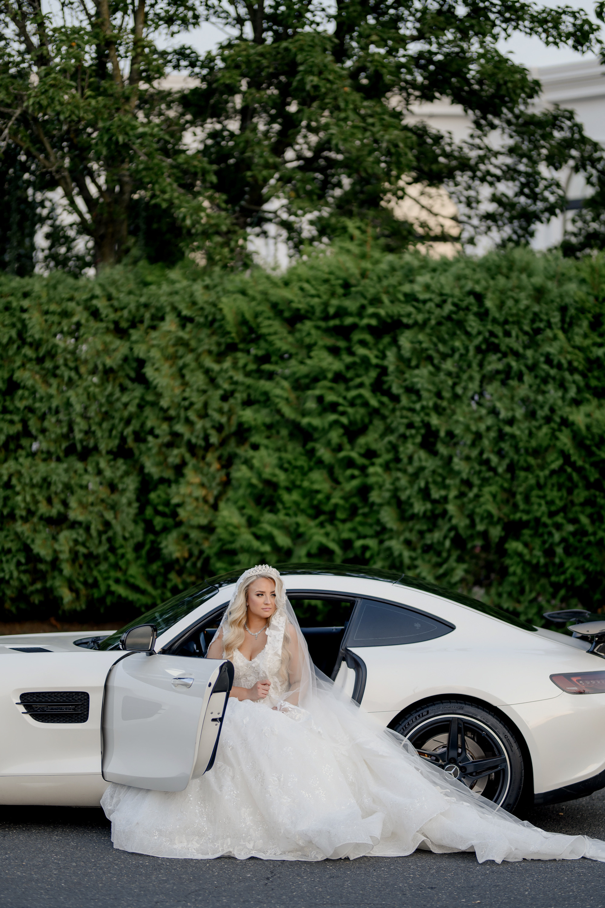 a bride sitting in a white sports car
