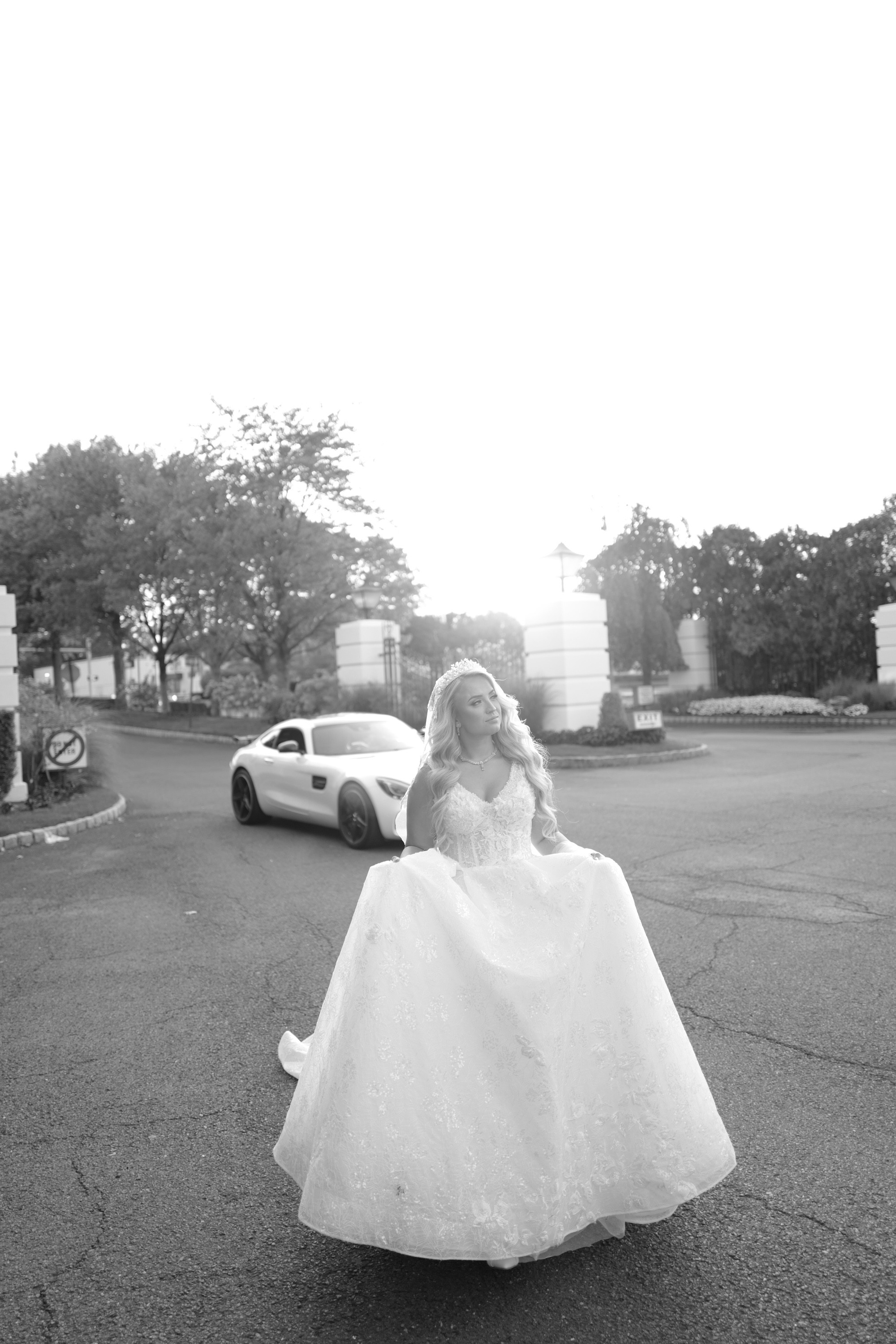 a little girl in a white dress is walking down the street