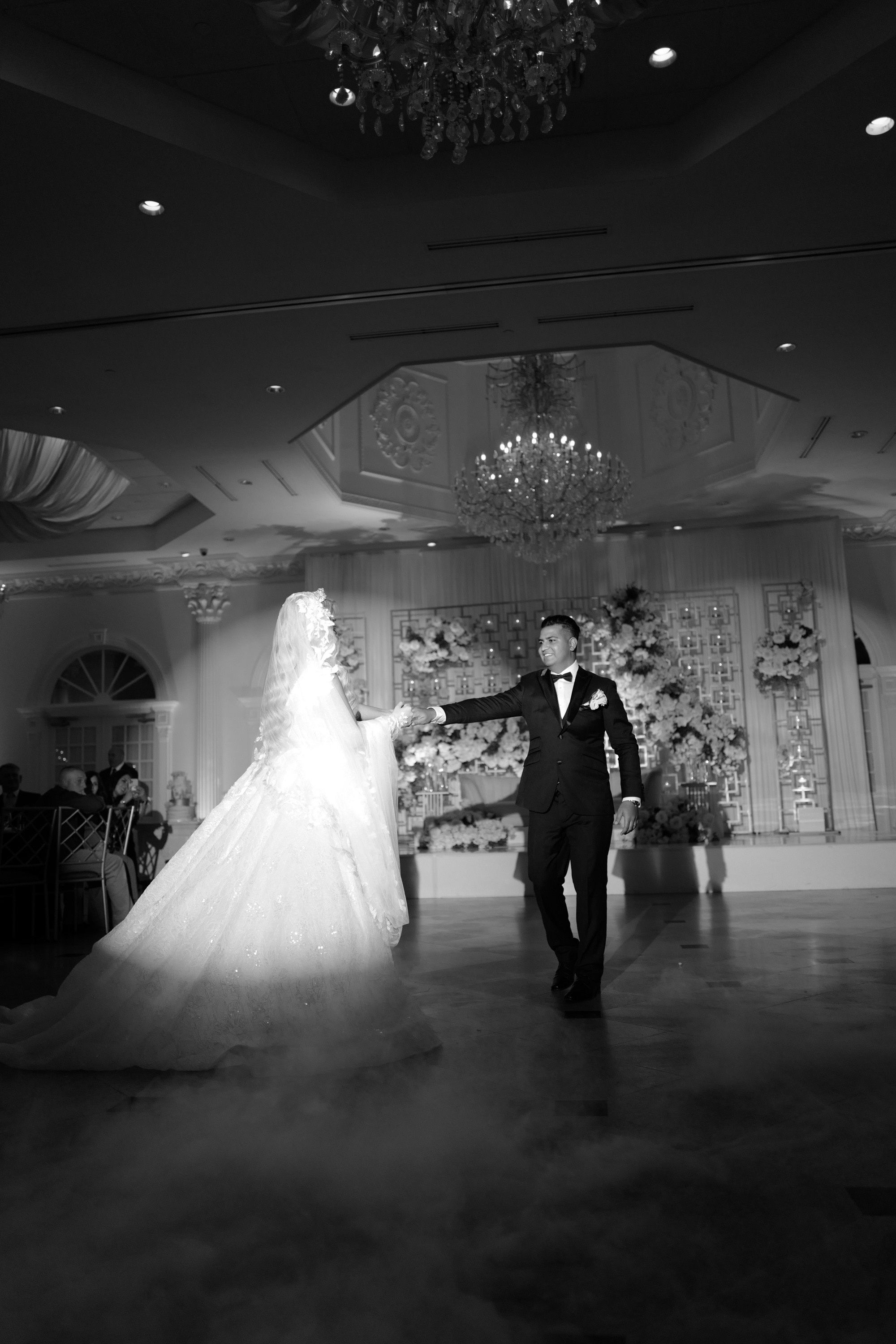 a bride and groom dancing in a ballroom