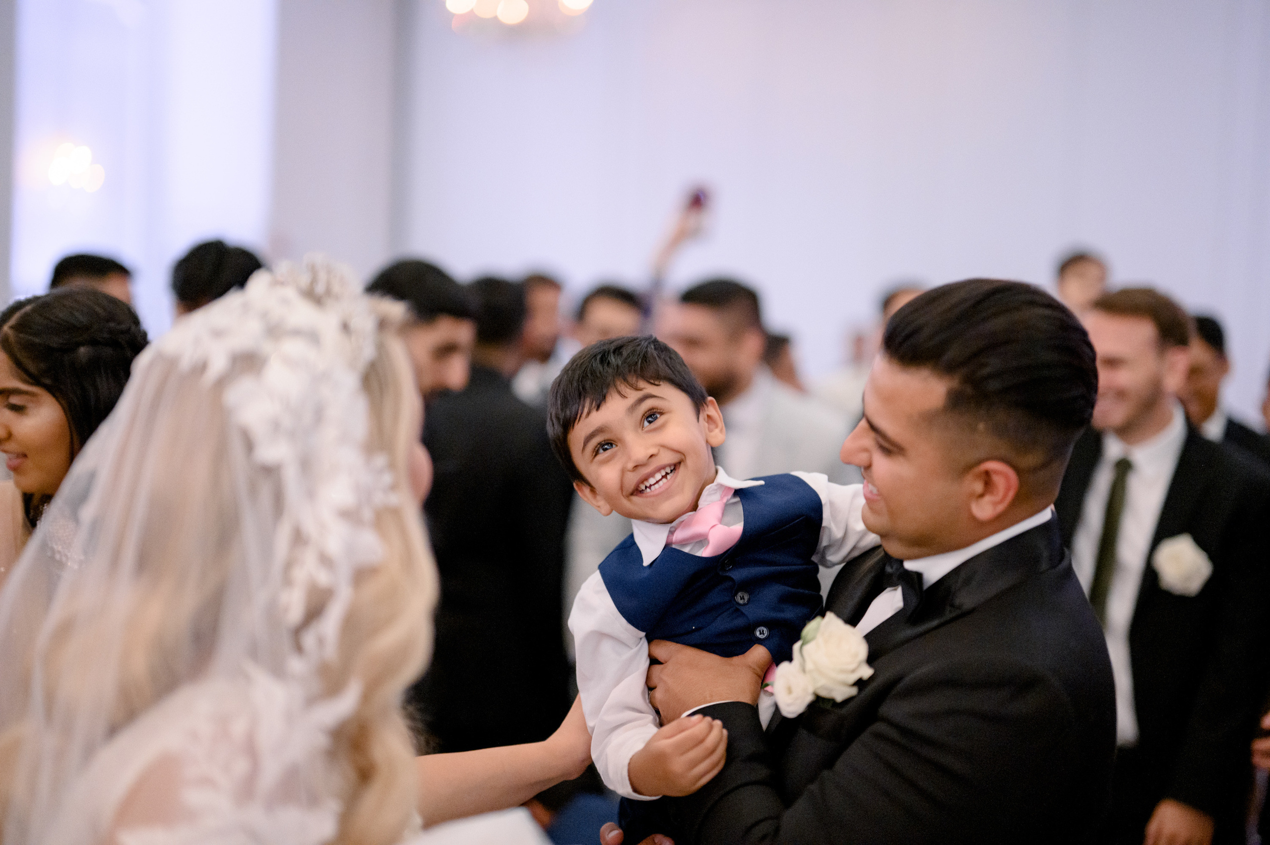 a young boy is holding a doll in his arms