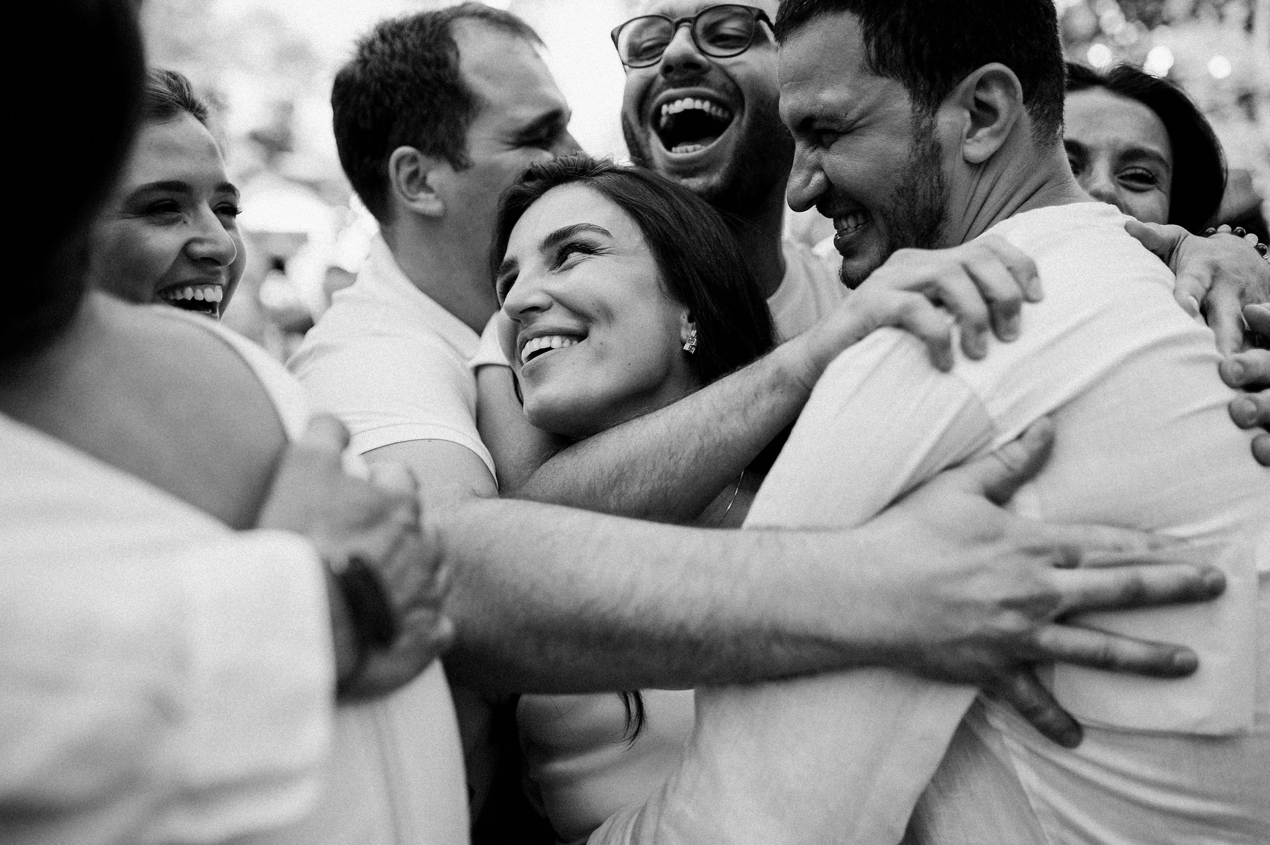 a group of people hugging and laughing