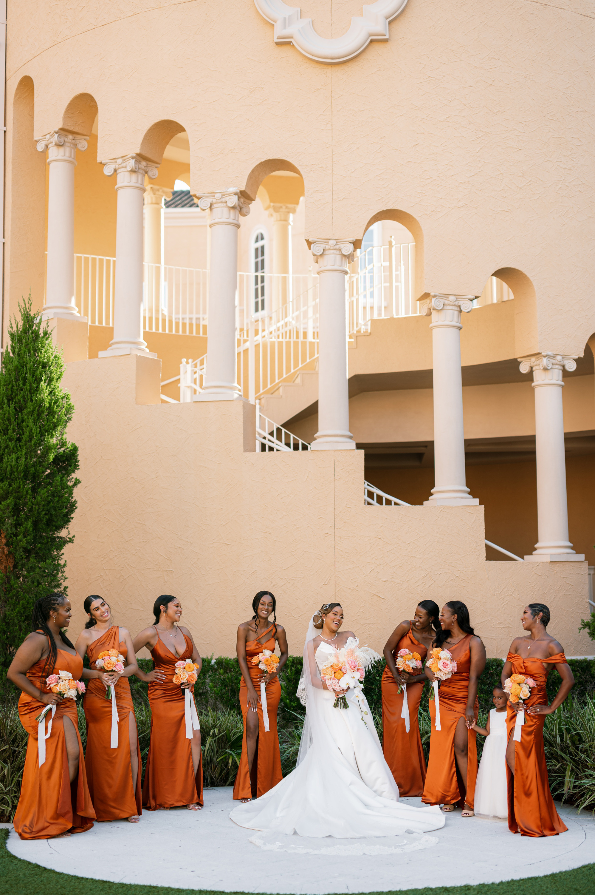 a group of bridesmaids in orange dresses