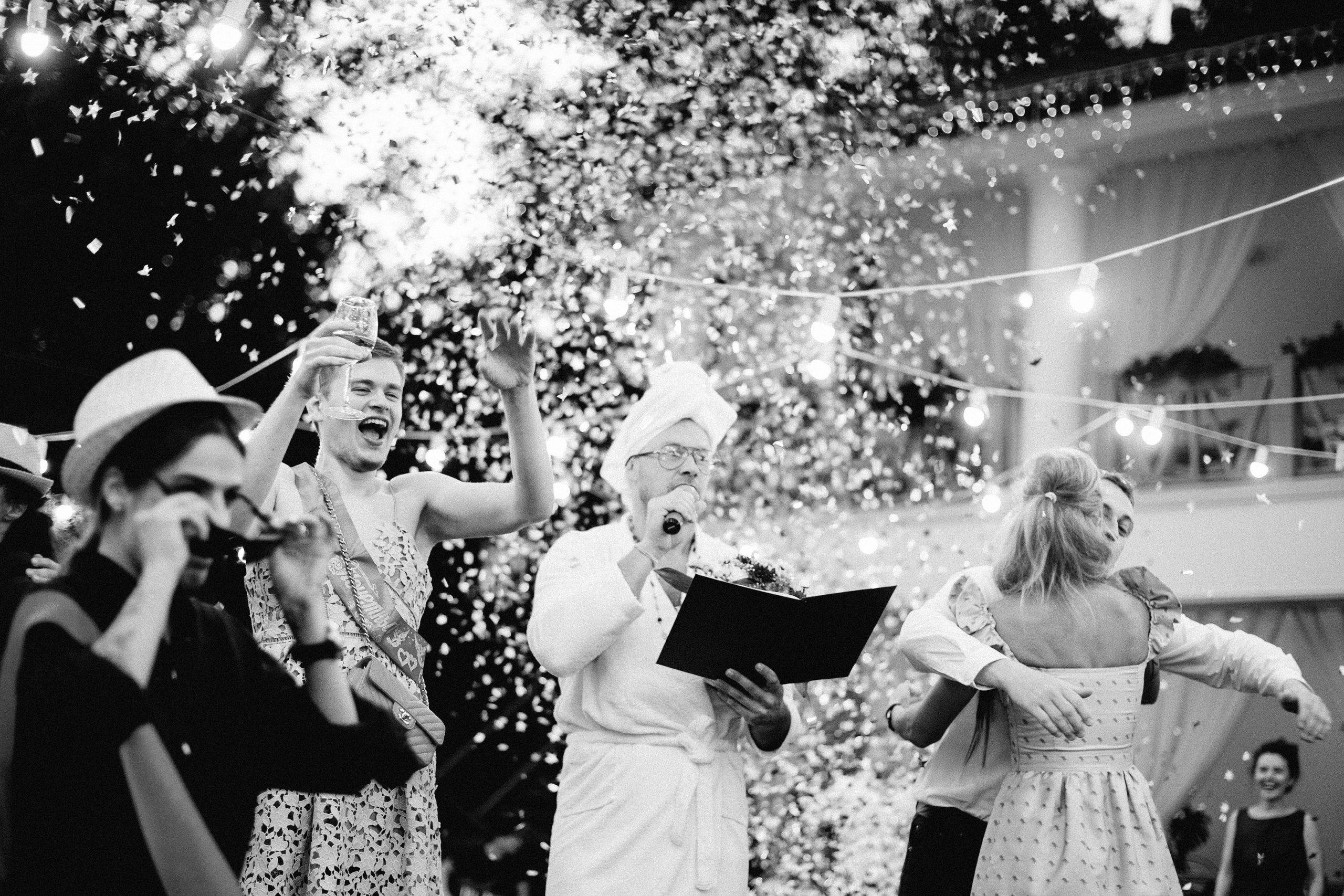 a group of people standing around a cake
