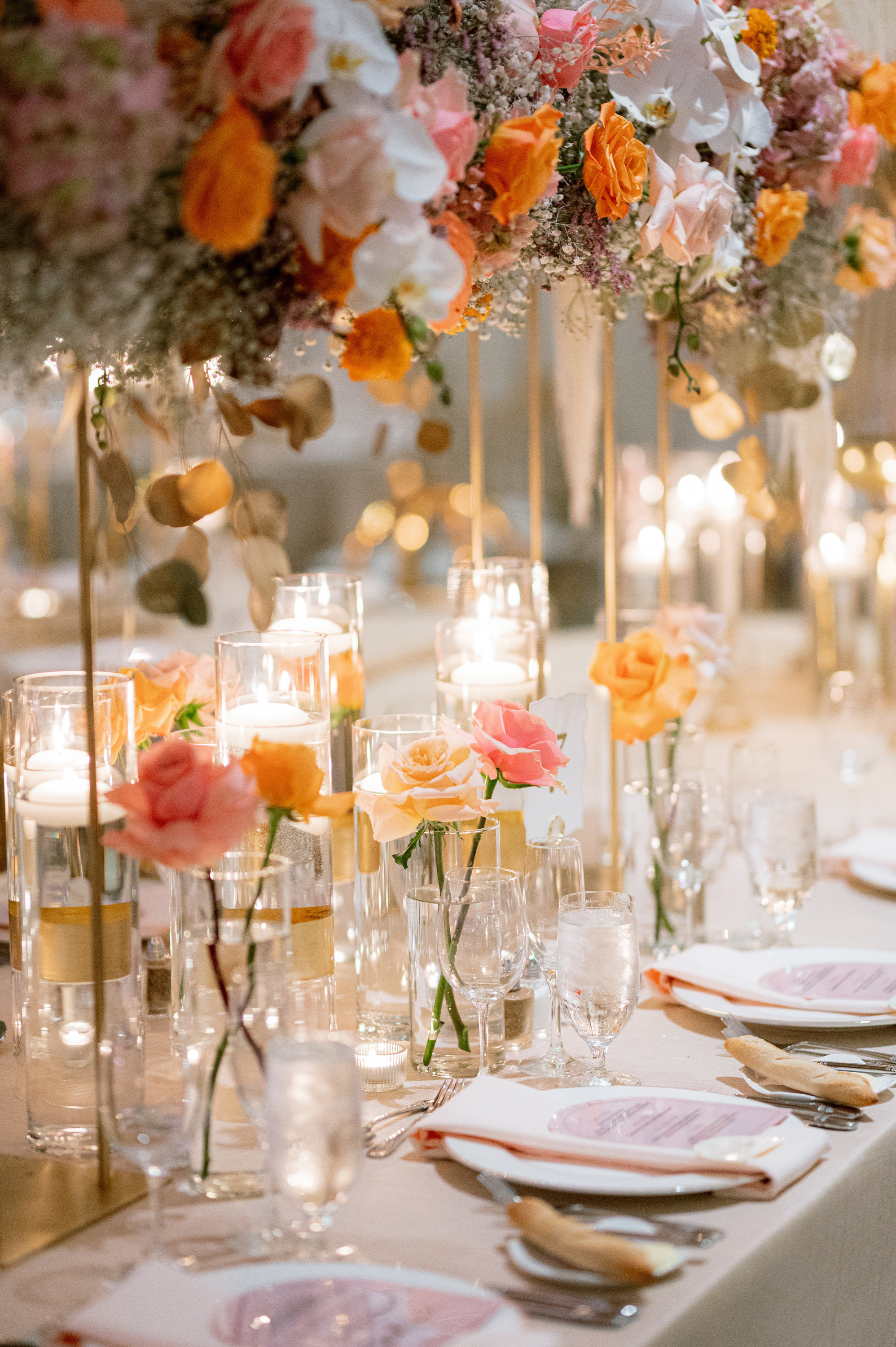 a table with a bunch of flowers and candles