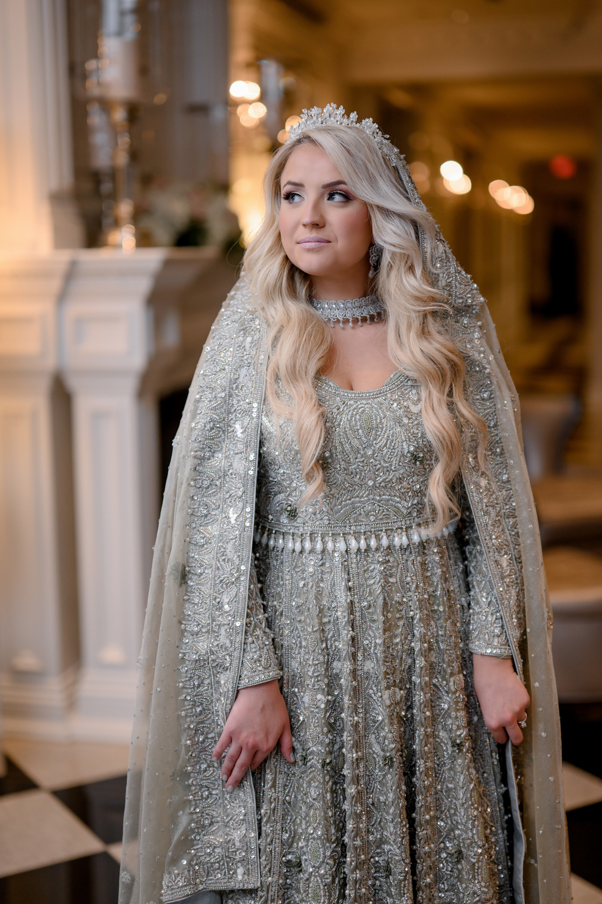 a woman in a silver dress and a silver cape