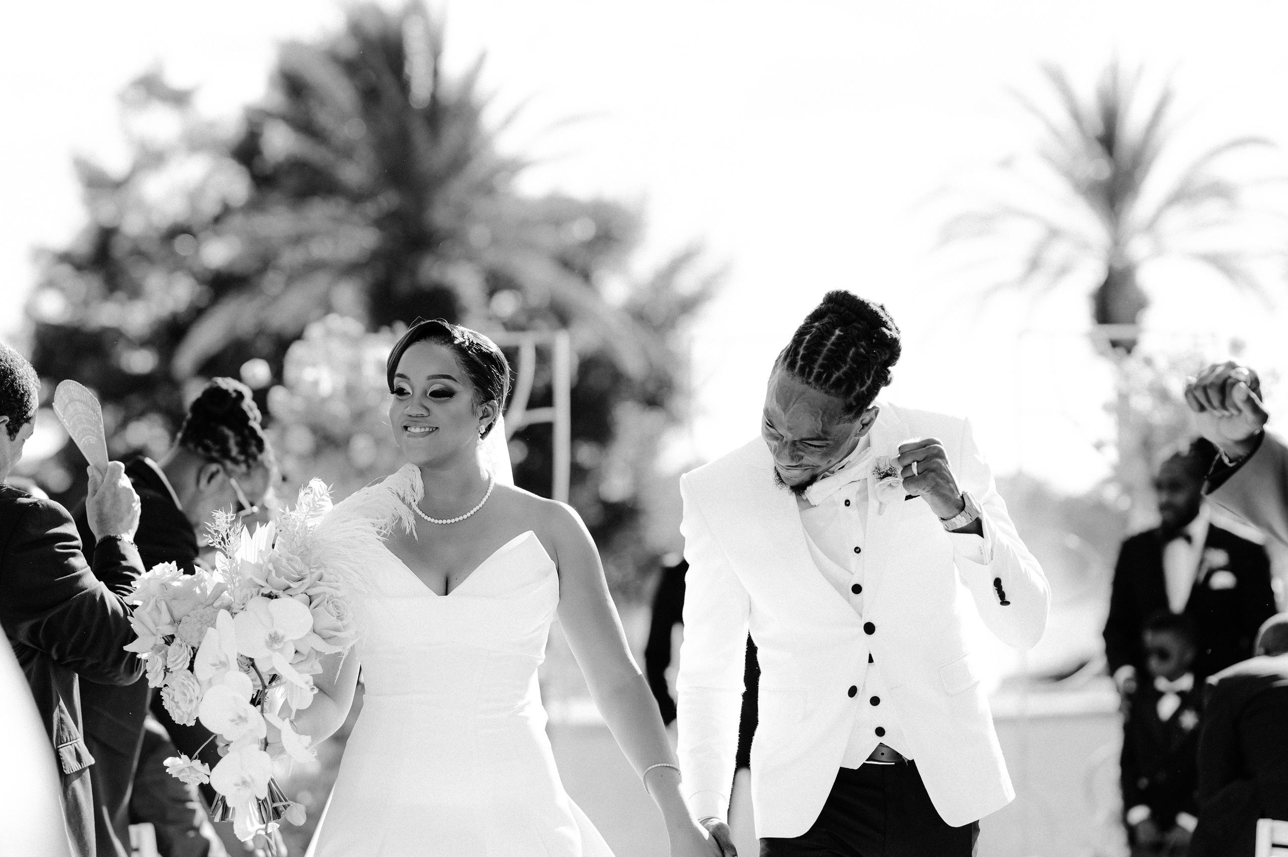a bride and groom walking down the aisle