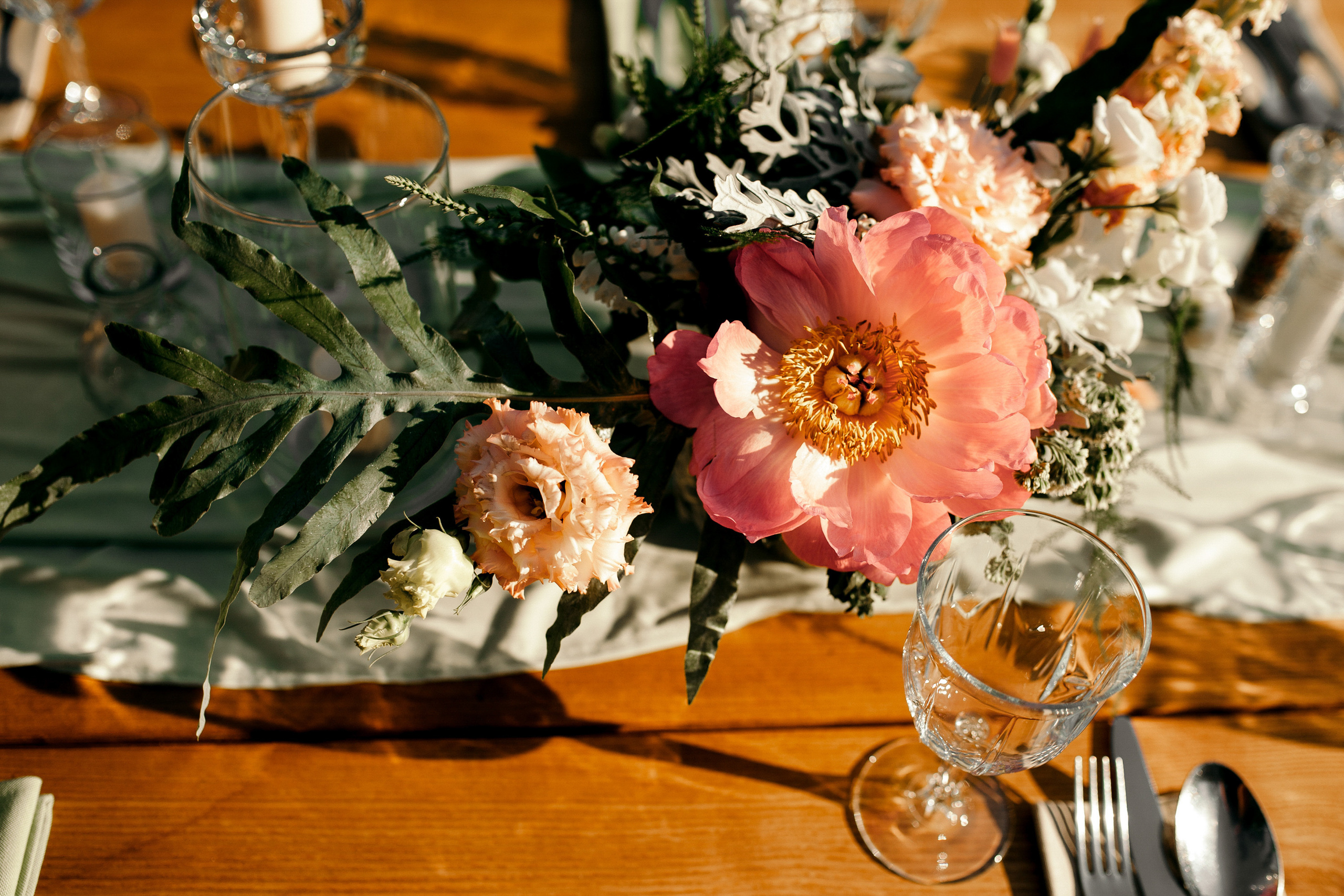 a table with a vase of flowers and a knife