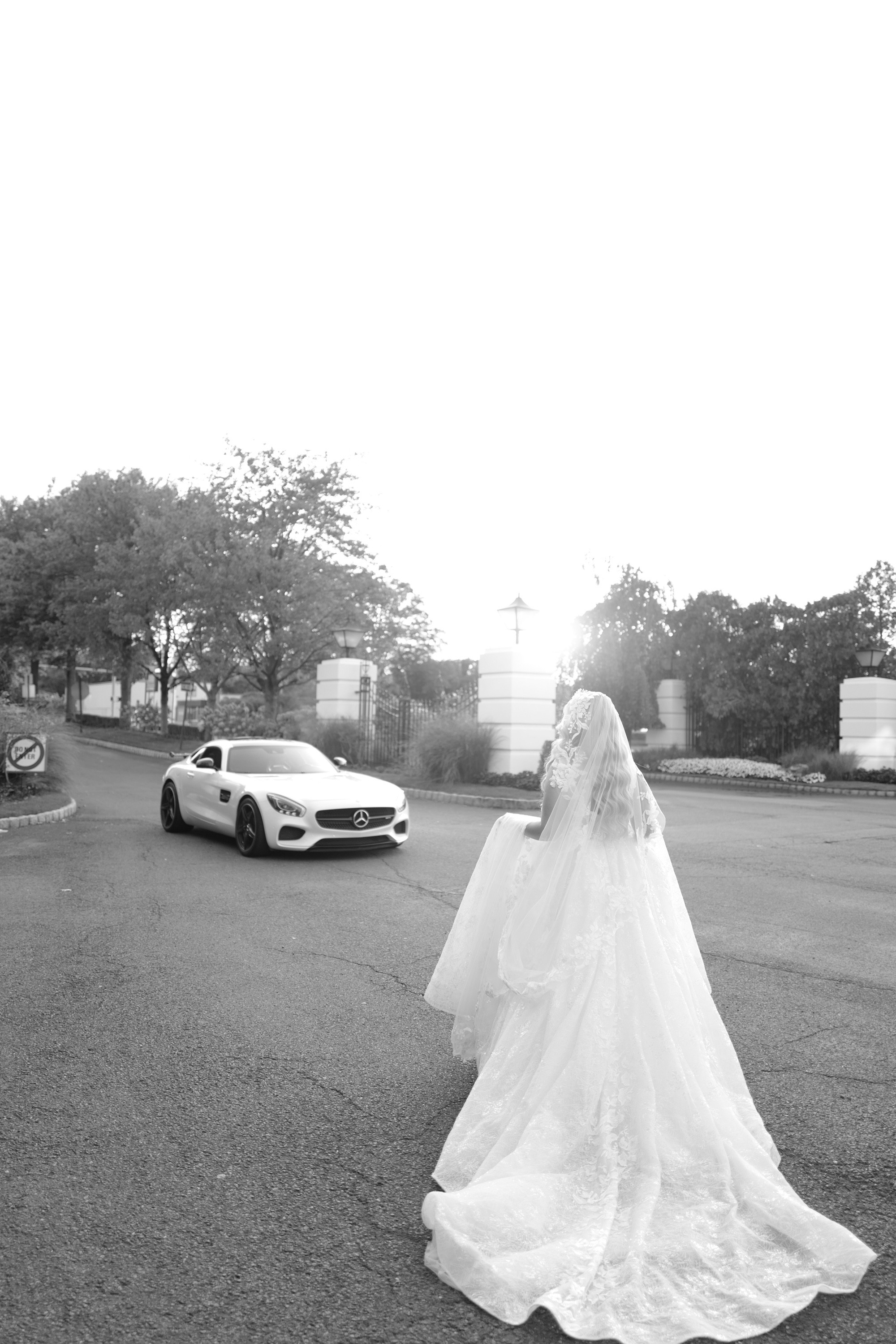 a bride walking down the street in front of her car