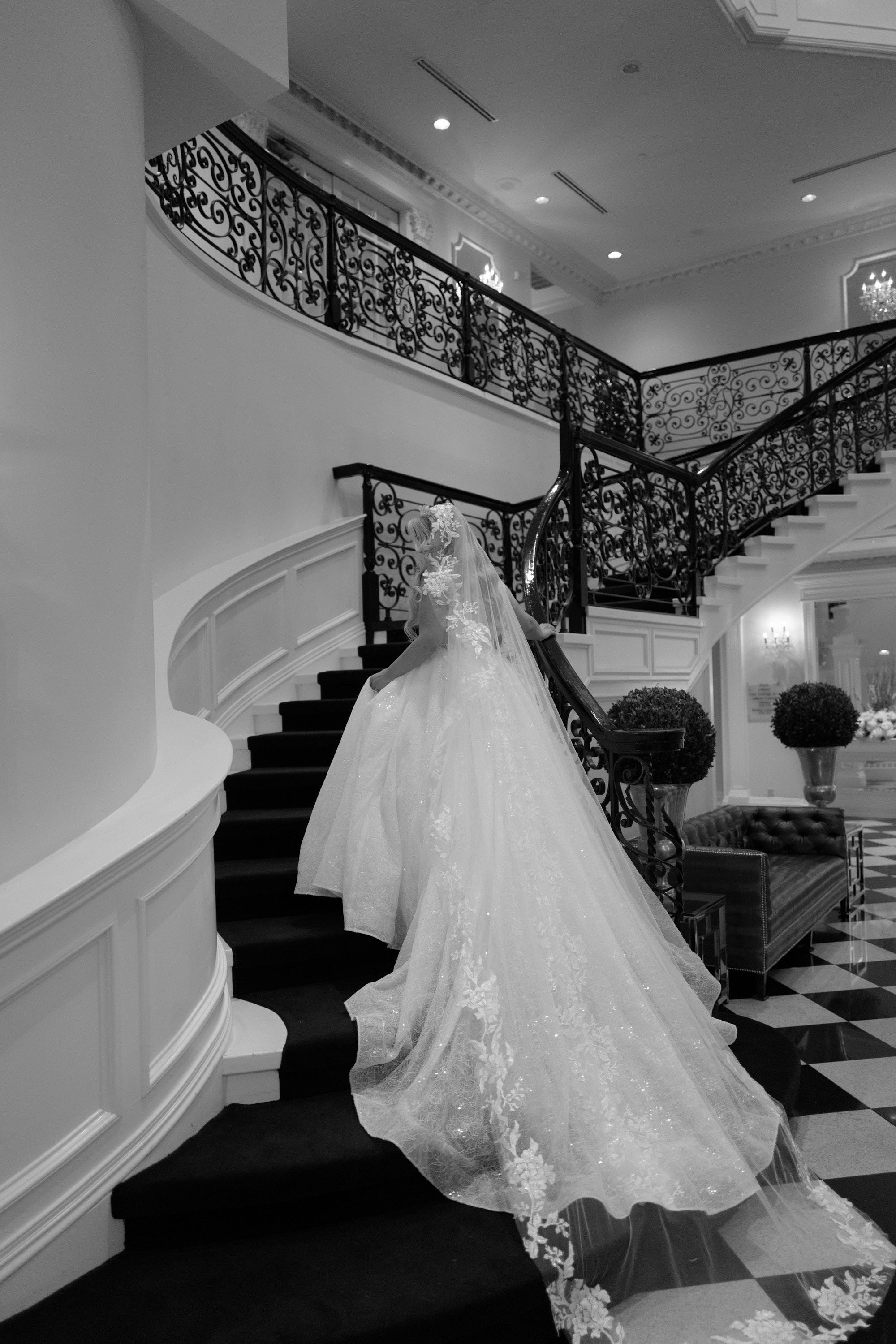 a bride walking down the stairs of a staircase