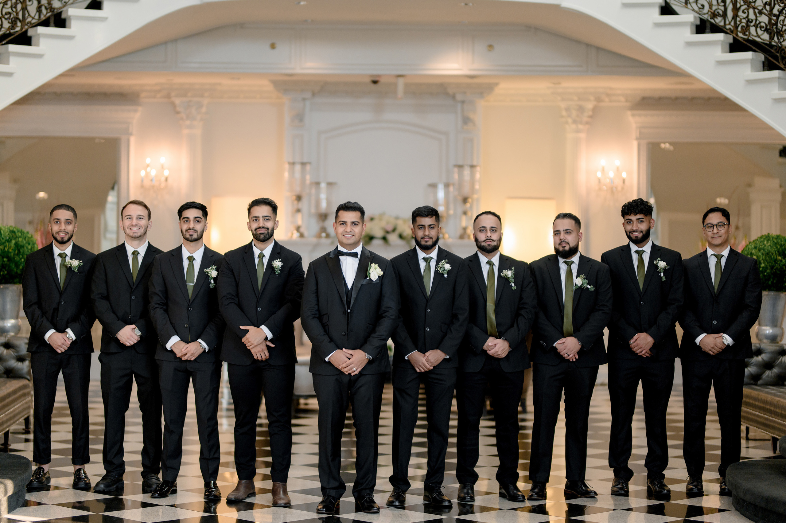 a group of men in suits standing in a room
