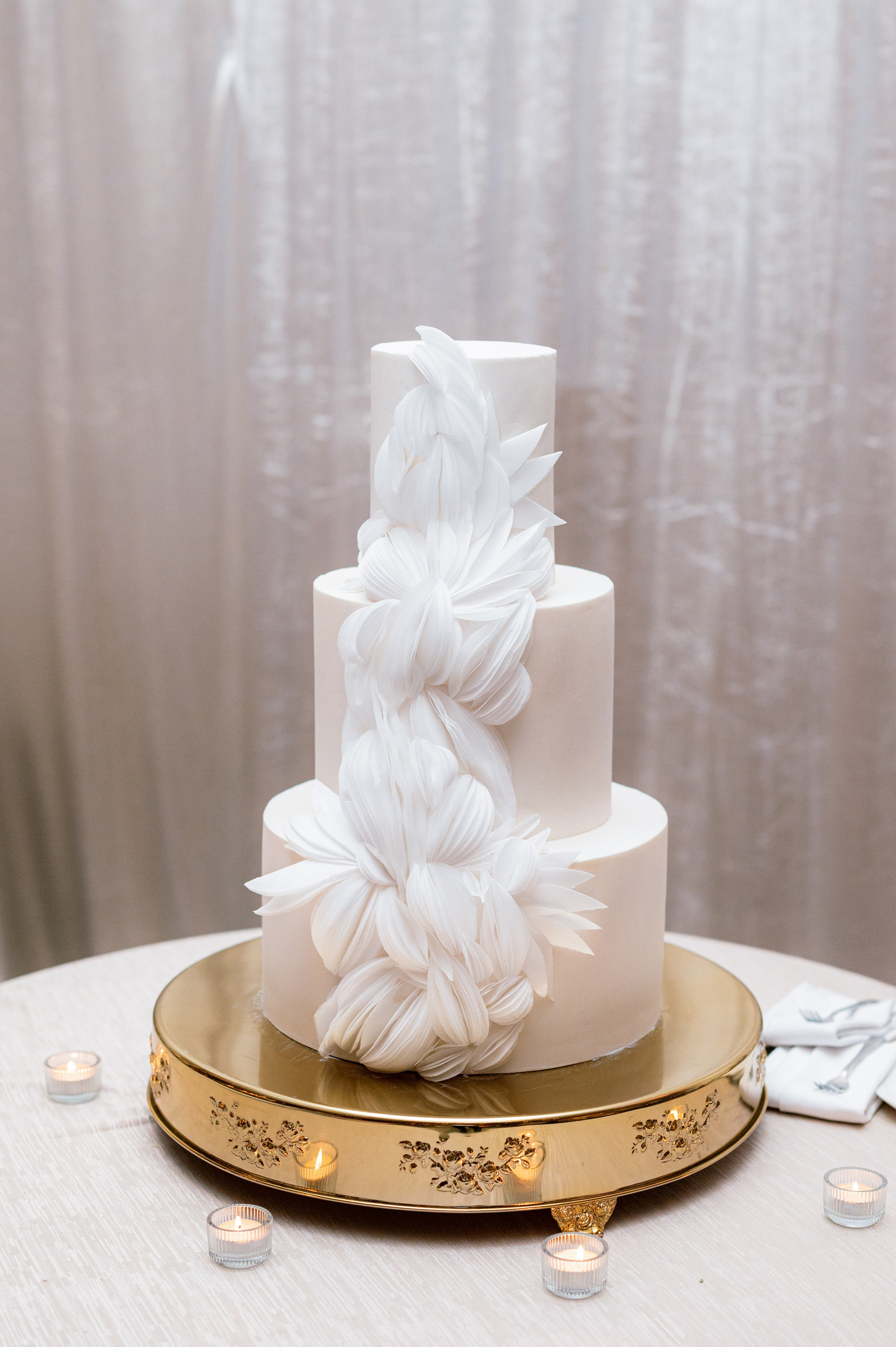 a white cake with a gold stand