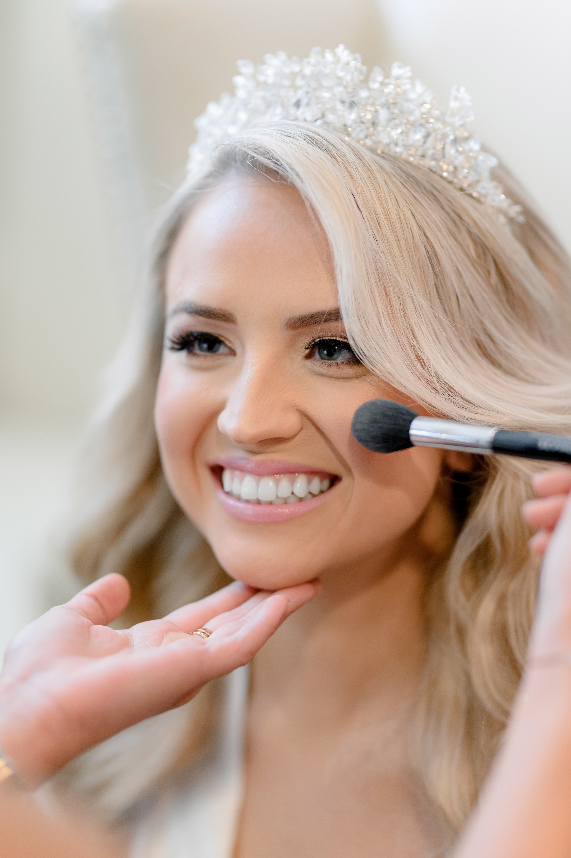 a bride putting her makeup brush