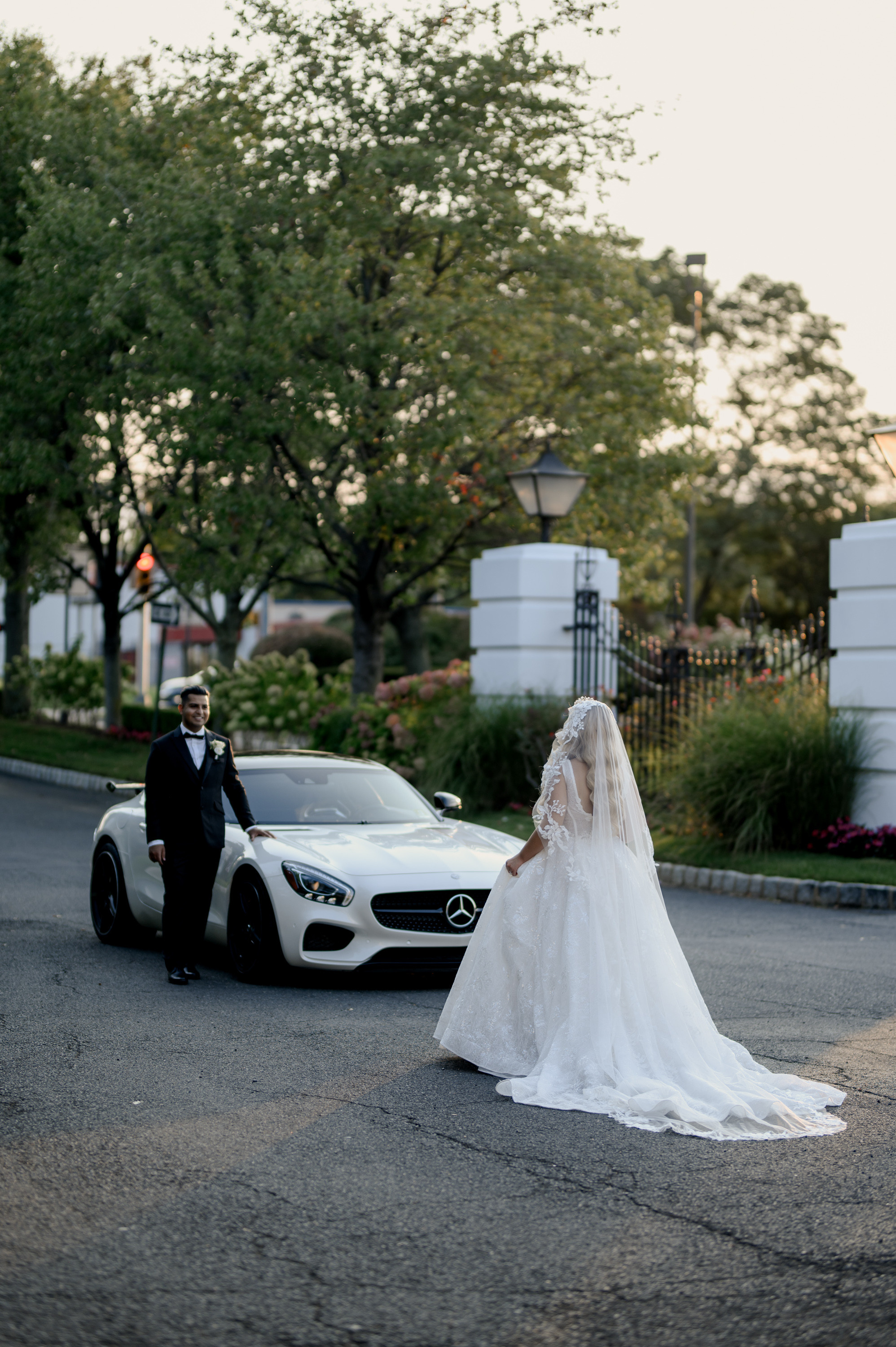 a bride and groom walking down the street