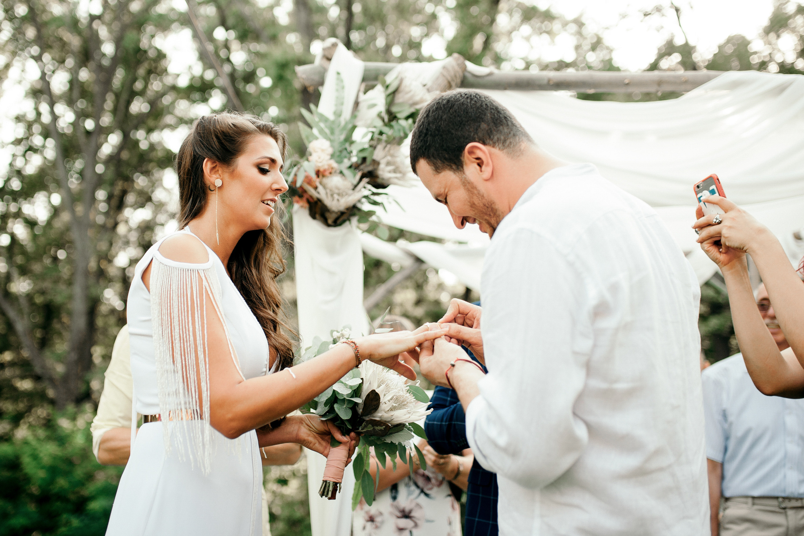 a man putting a ring on a woman's finger