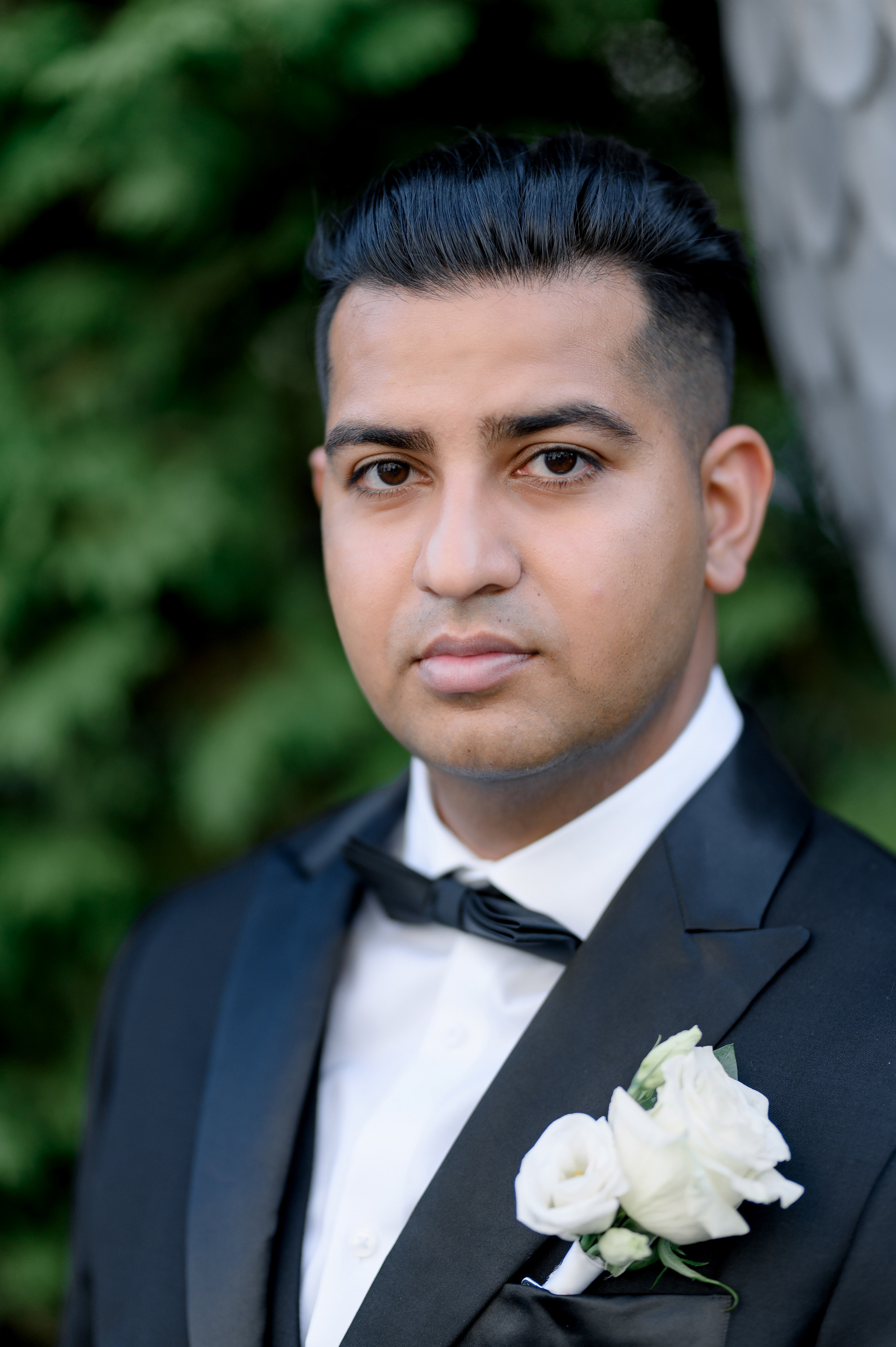 a man in a suit and tie with a flower