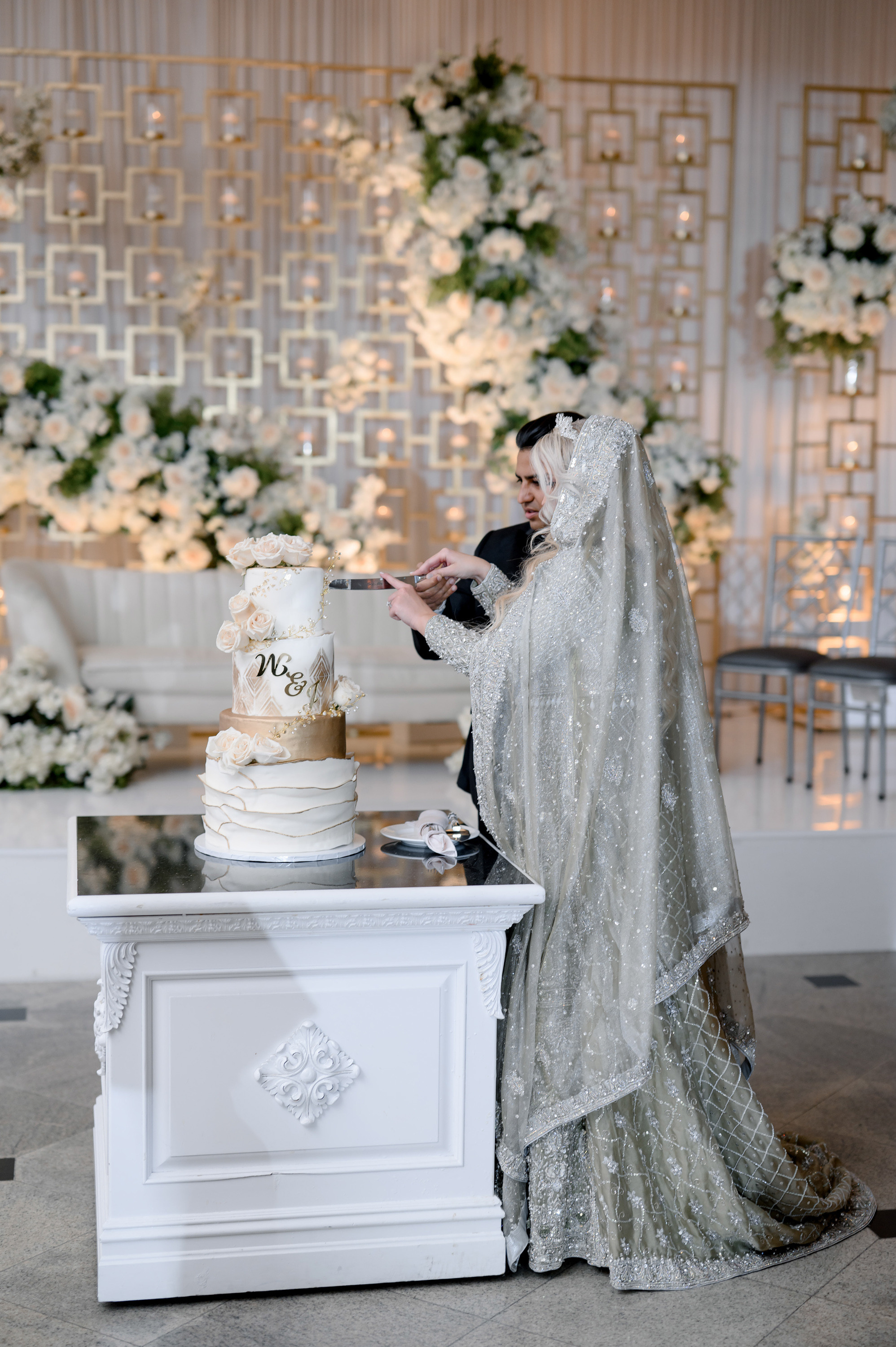 a bride and groom cutting their wedding cake