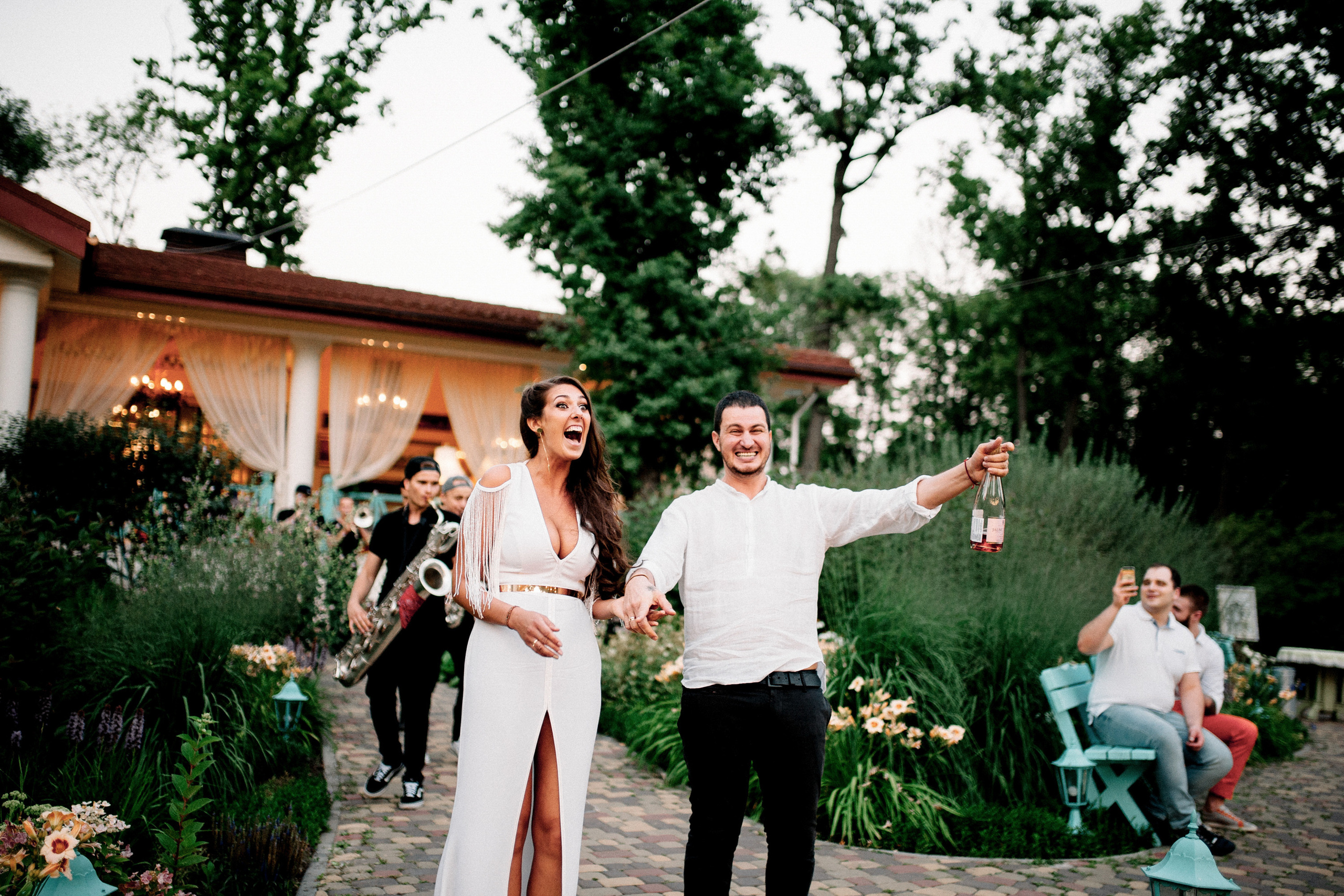 a man and woman are standing on a brick walkway