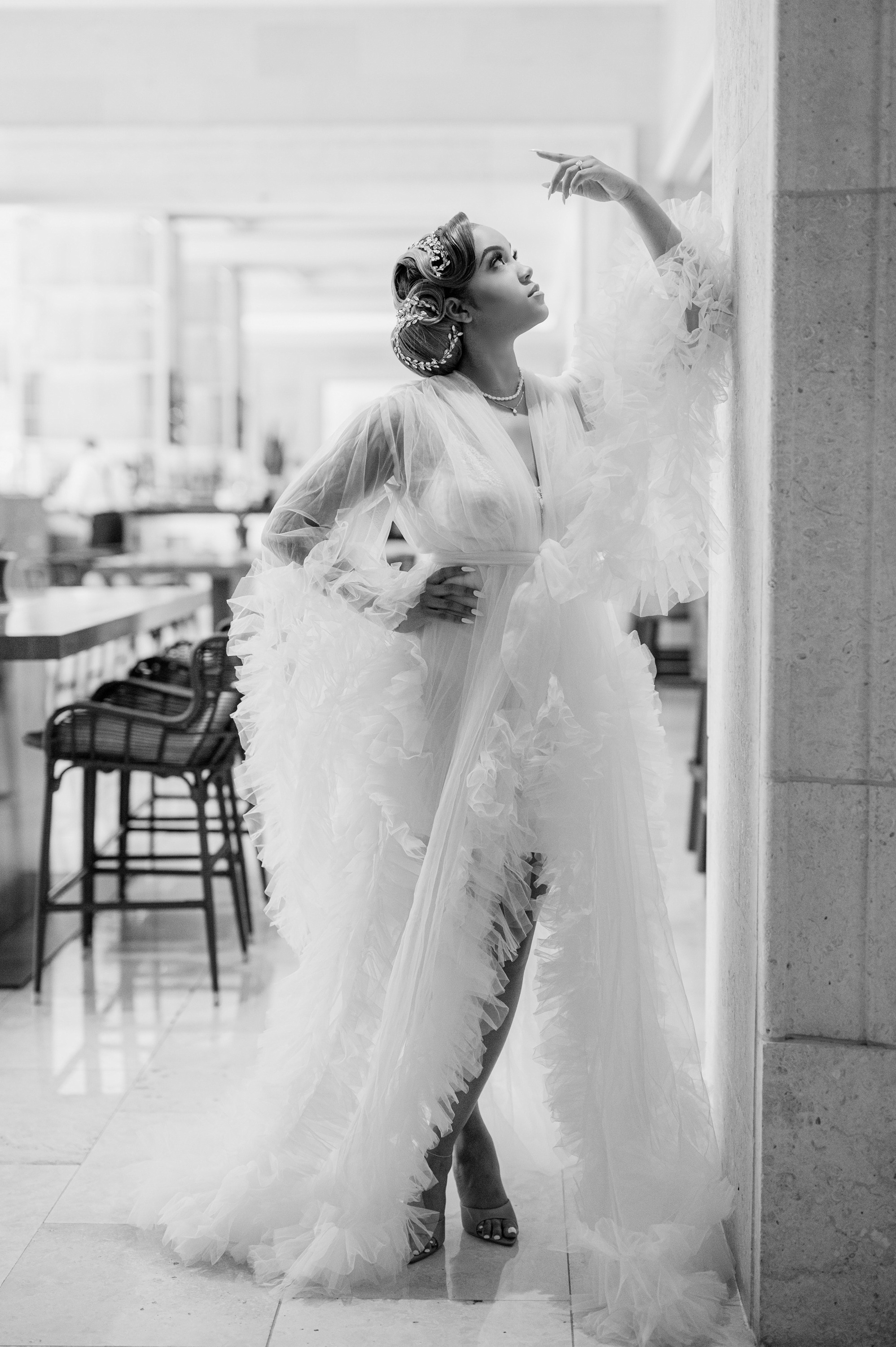 a woman in a wedding dress standing in a room