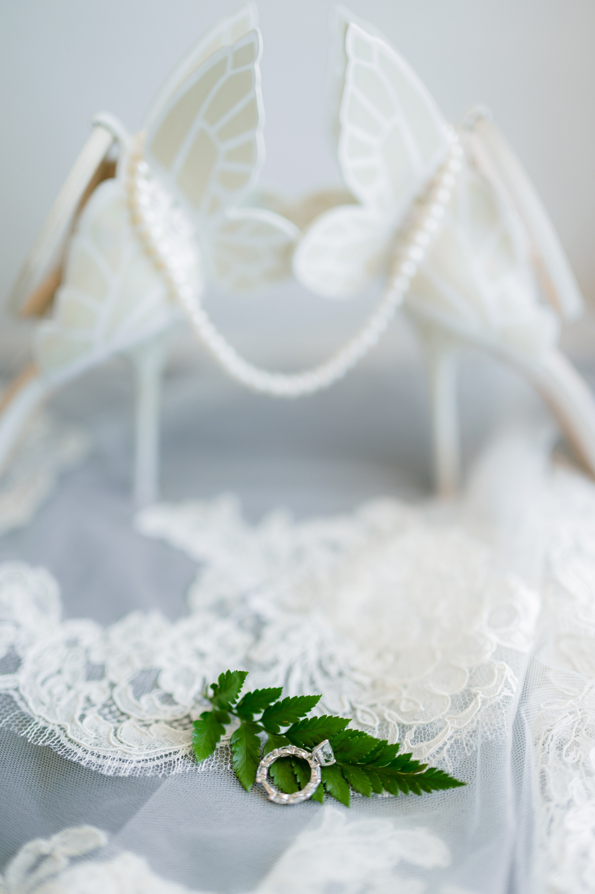 a wedding ring sits on a white lace