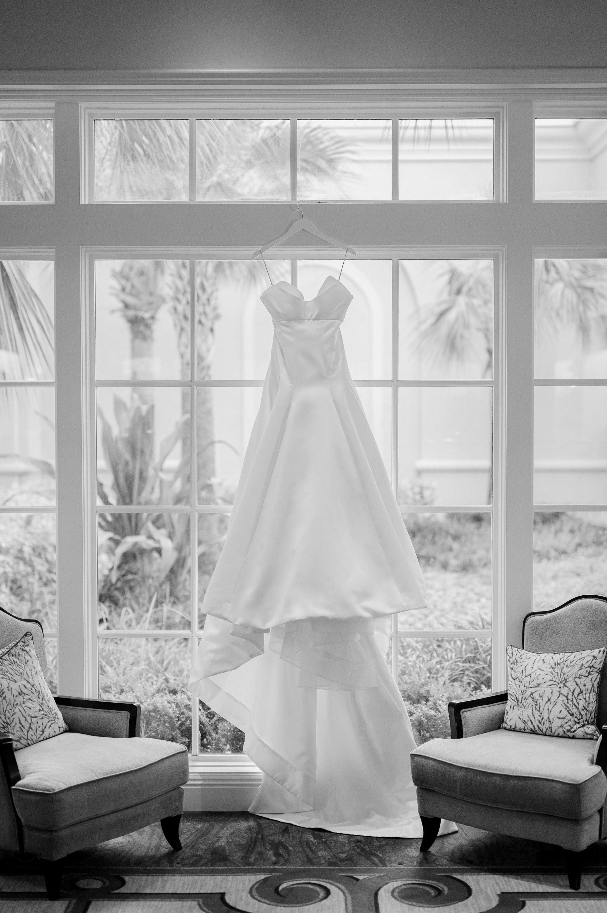 a wedding dress hanging in a window