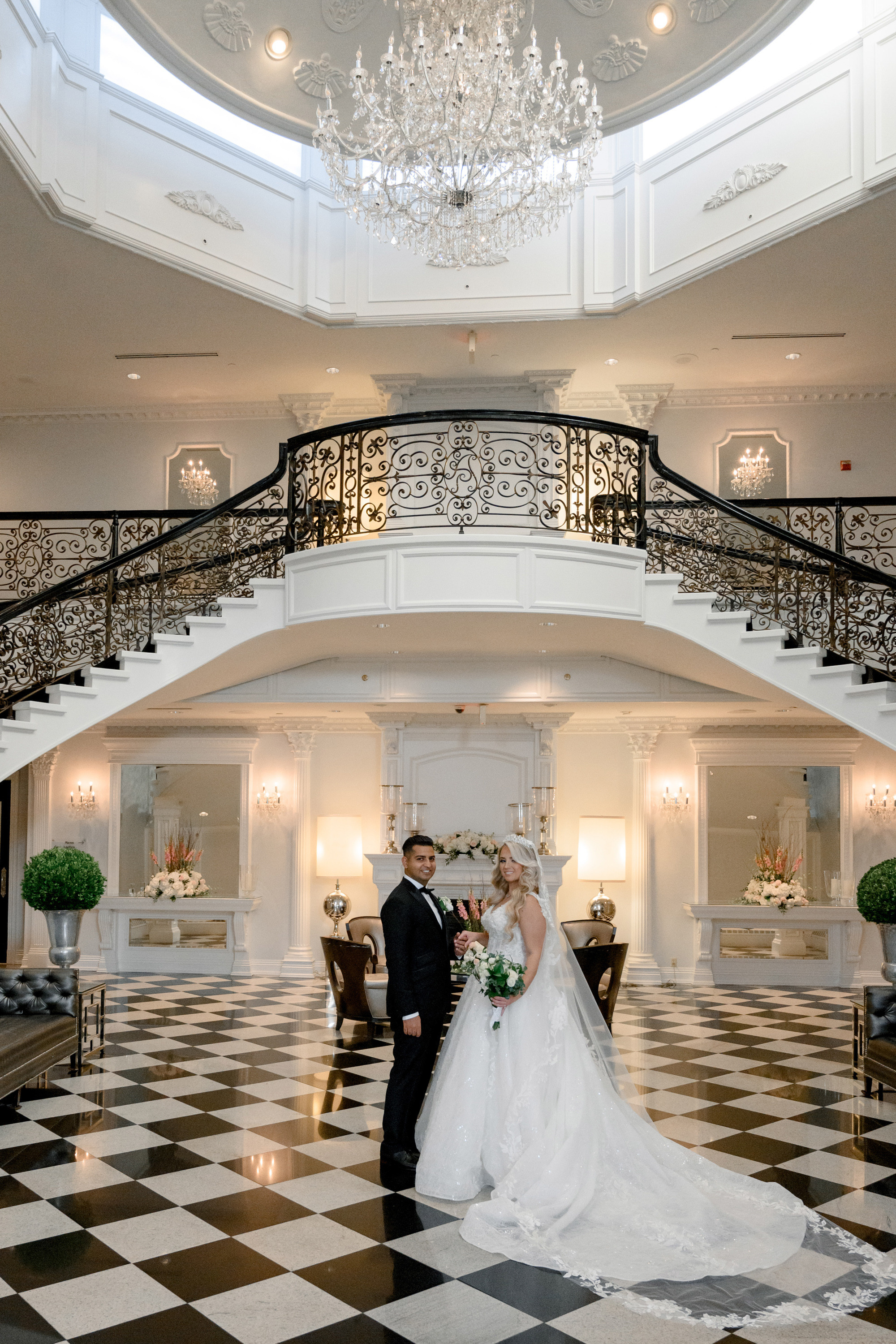 a bride and groom standing in a large room