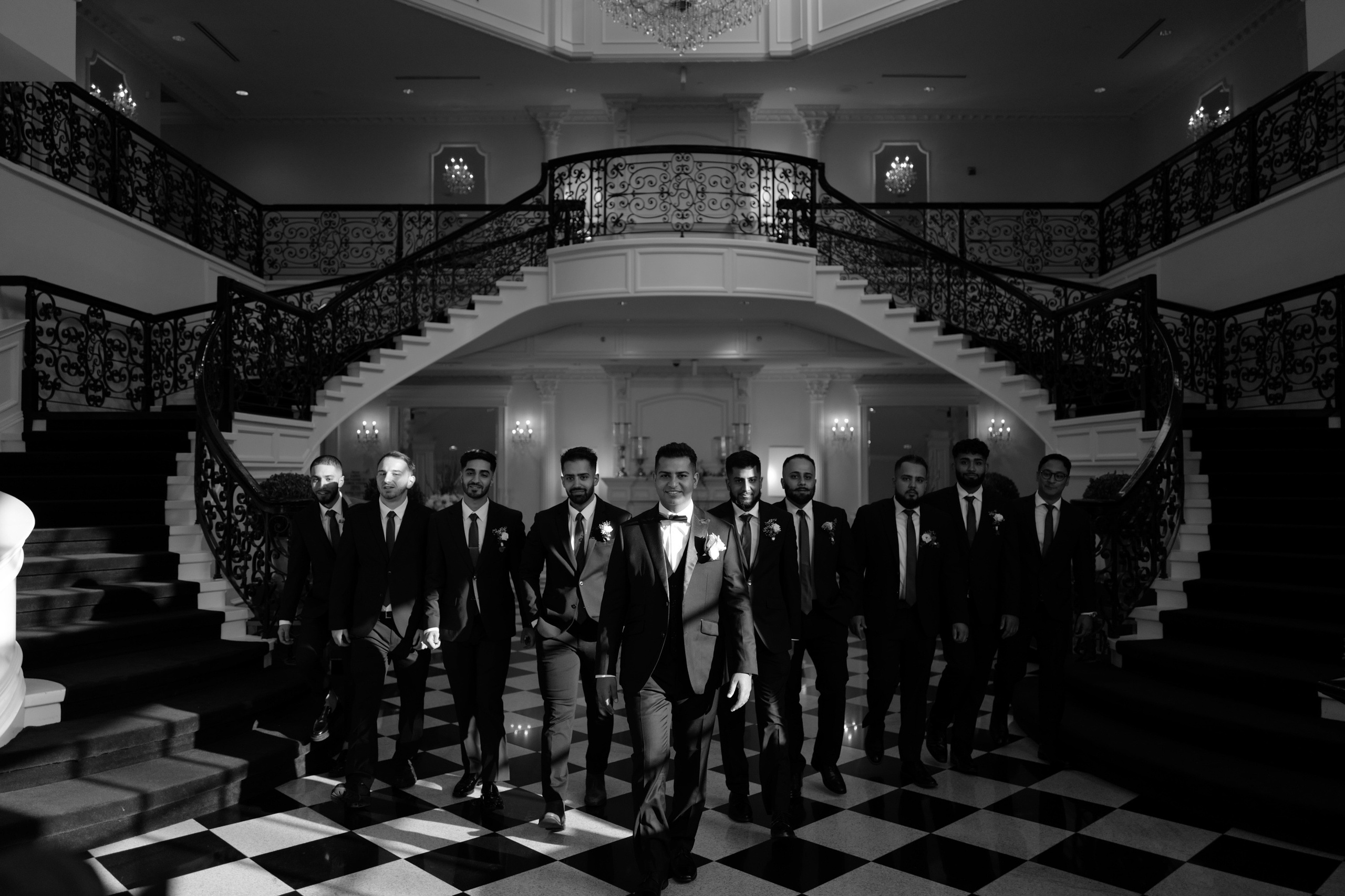 a group of men in suits standing in a room