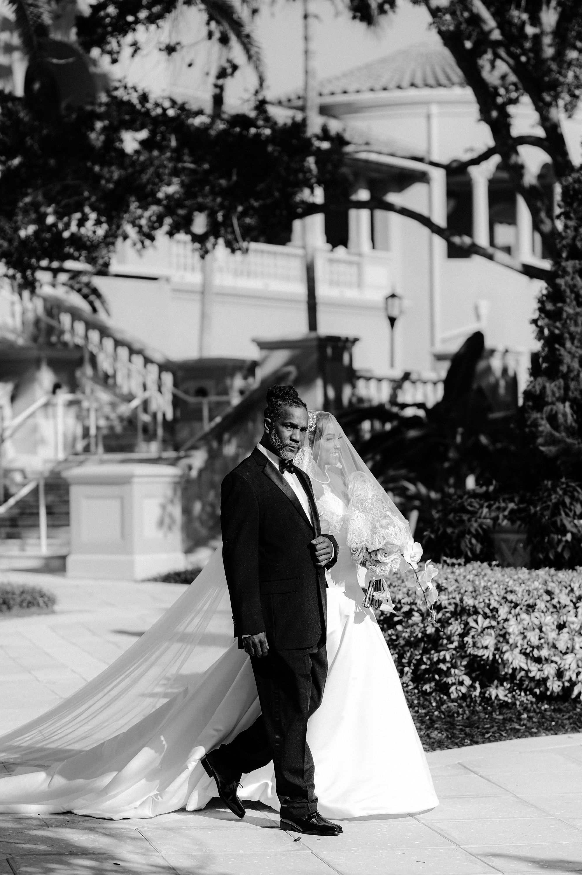 a bride and groom walking down the street