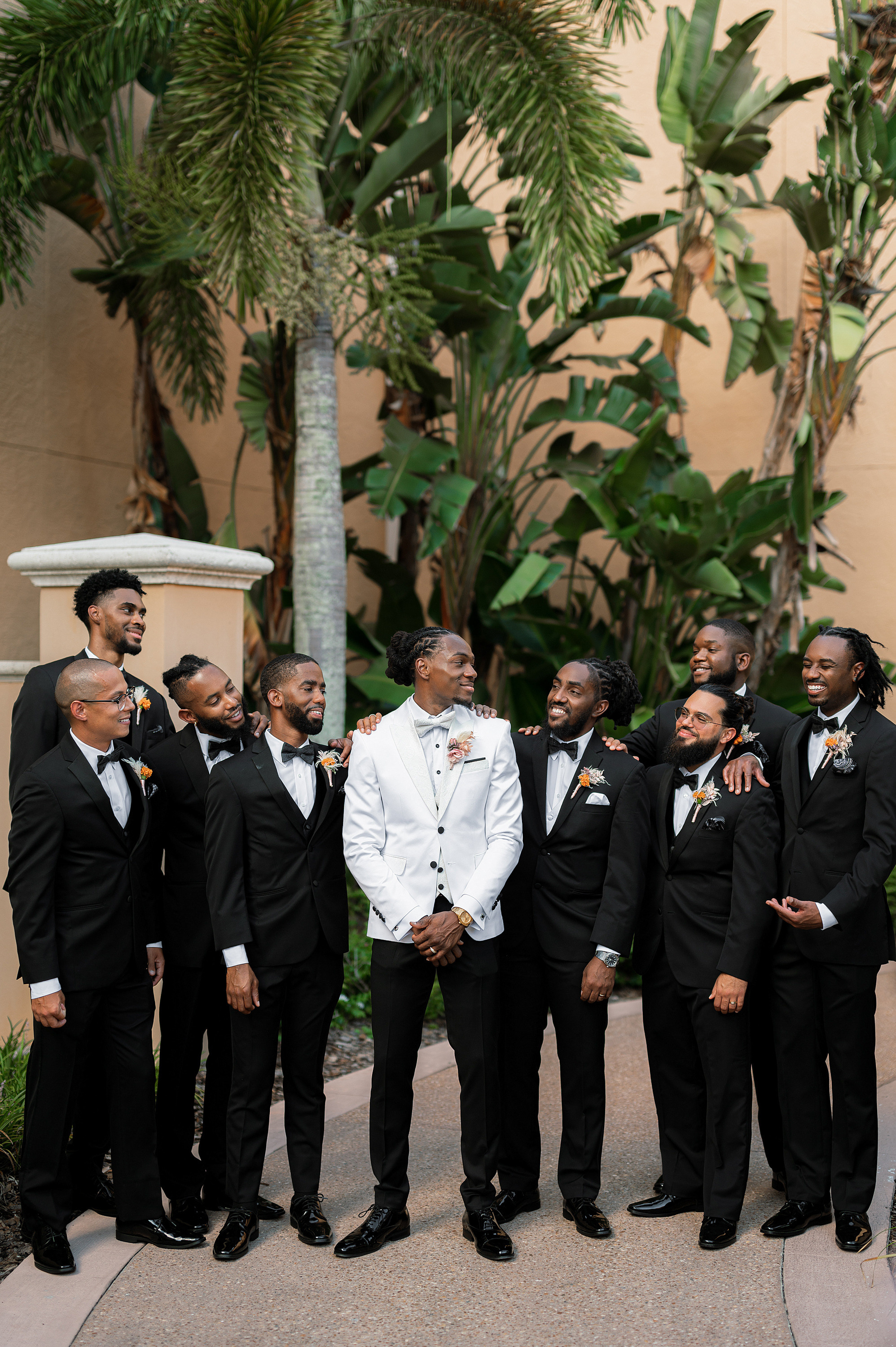 a group of men in tuxed suits standing together